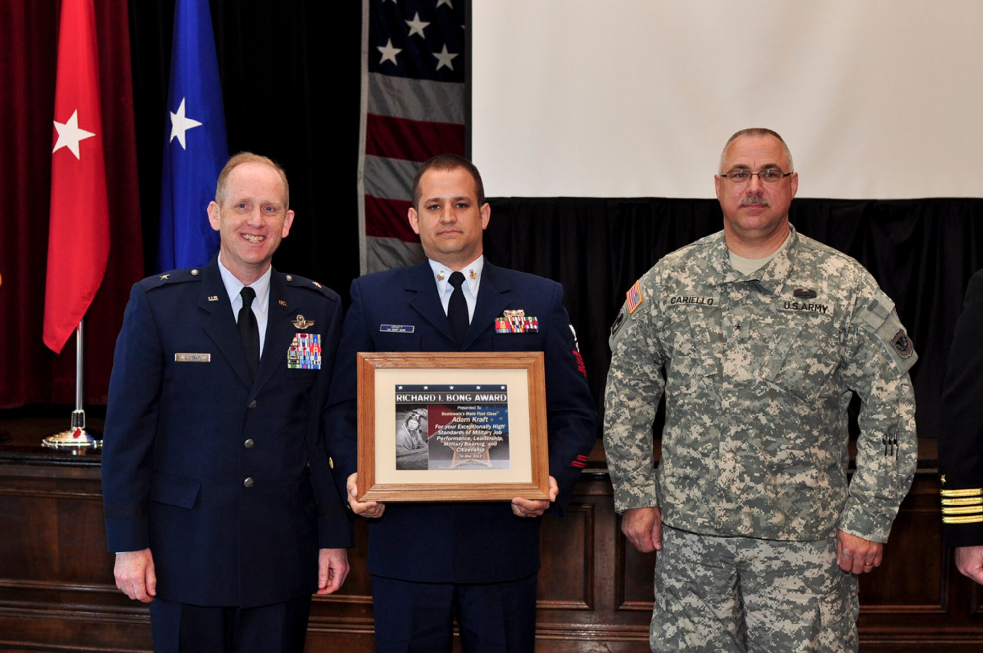 Boatswain’s Mate First Class Adam Kraft of the US Coast Guard: Sector Lake Michigan, receives the Bong Award during the ESGR breakfast held at the Wisconsin Club in downtown Milwaukee, May 16, 2011. Each year the Milwaukee Armed Forces Committee and Wisconsin Committee for Employer Support of the Guard and Reserve (ESGR) recognize the men and women who serve the armed forces and the employers that support them. U.S. Air Force photo by Tech Sgt. Thomas J Sobczyk  / Released