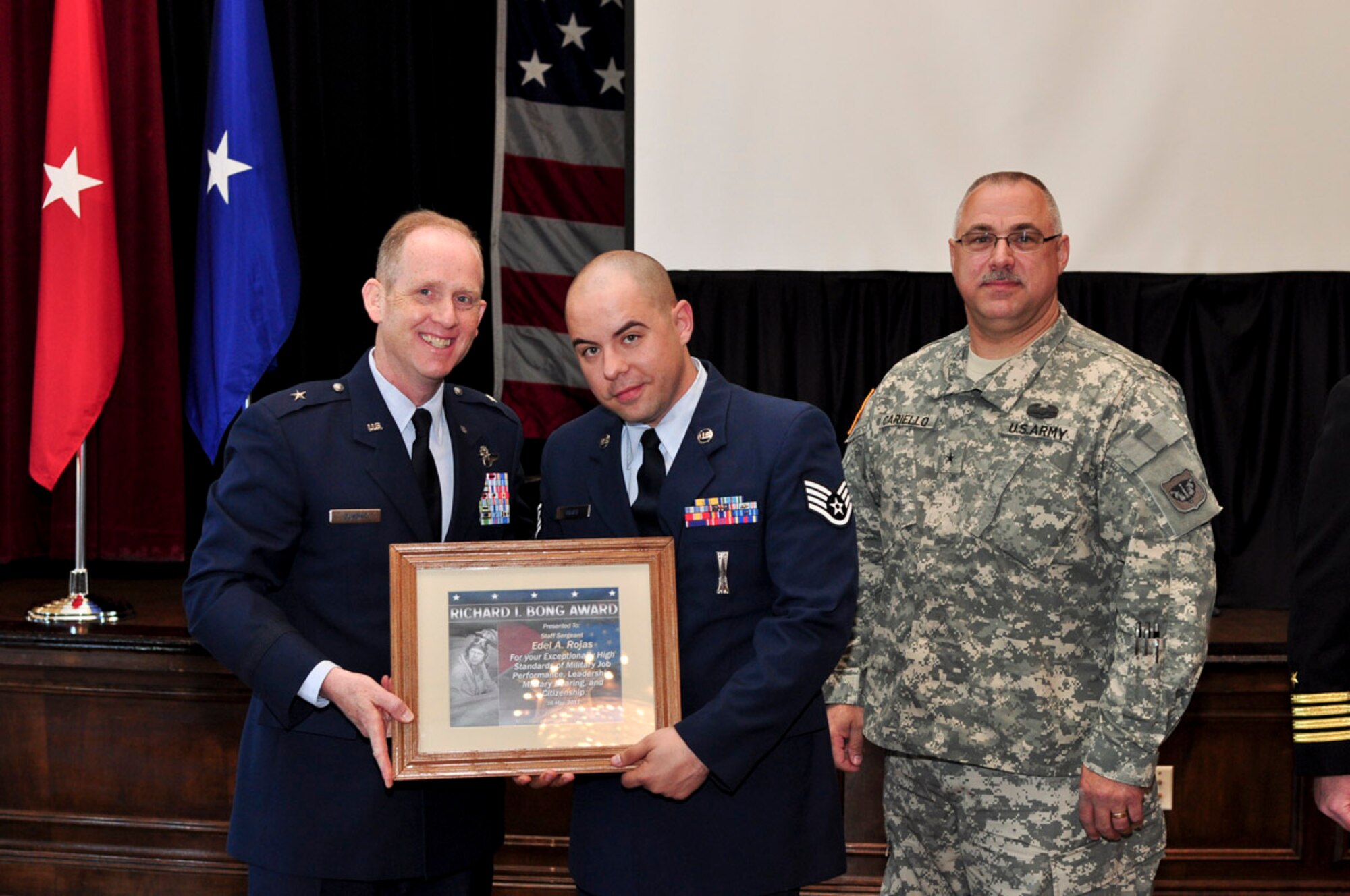 Staff Sergeant Edel Rojas of the 347th Recruiting Squadron receives the Bong Award during the ESGR breakfast held at the Wisconsin Club in downtown Milwaukee, May 16, 2011.  Each year the Milwaukee Armed Forces Committee and Wisconsin Committee for Employer Support of the Guard and Reserve (ESGR) recognize the men and women who serve the armed forces and the employers that support them. U.S. Air Force photo by Tech Sgt. Thomas J Sobczyk  / Released