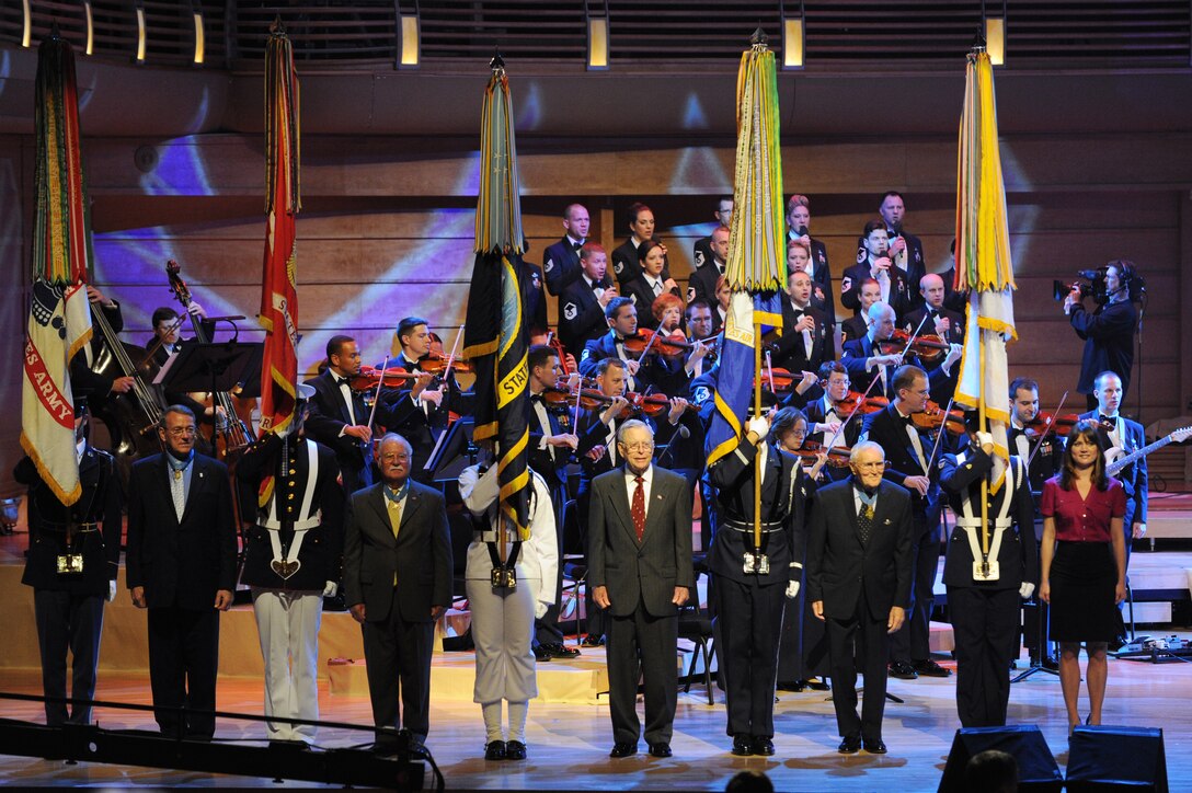 From left to right, retired Col. Roger Donlon, retired Col. Harvey C. Barnum Jr., retired Rear Adm. Jeremiah A. Denton Jr., retired Col. George Everette Day, and Mrs. Kristin Lunkley, veteran honorees, are recognized at The US. Air Force Band’s concert May 12 at the Music Center at Strathmore, Bethesda, Md. The performance was part of “America’s Veterans: A Musical Tribute,” which was taped for broadcast, to be aired on Veterans Day. (U.S. Air Force photo by Senior Airman Christopher Ruano)