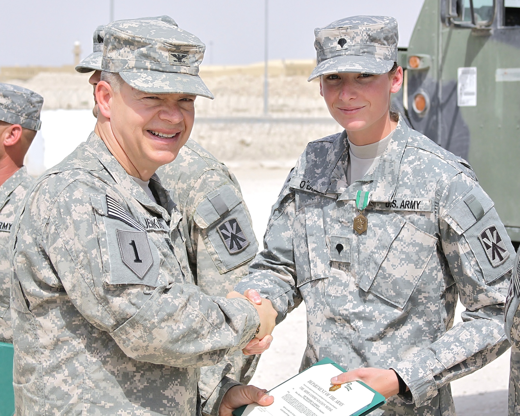 U.S. Army Col. James H. Jenkins III, 69th Air Defense Artillery Brigade commander, awards the Army Commendation Medal to Spc. Mallory O’Brien, a member of the Bravo Battery launcher reload crew, at an award ceremony April 29 in Southwest Asia. (U.S. Army photo/Sgt. Daniel Aguilar)