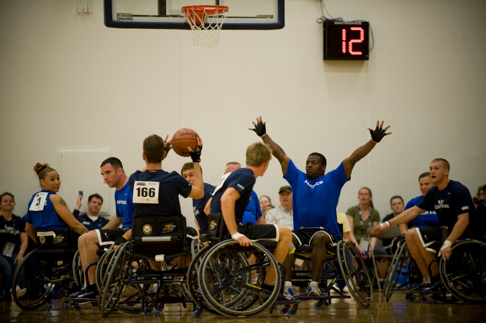 Air Force wheelchair basketball team members scramble as a Navy team member prepares to shoot during their game May 17, 2011, at the 2011 Warrior Games in Colorado Springs, Colo.  The Navy beat the Air Force 23-14 and next will face the Marine Corps.  The Air Force team plays the Army. (U.S. Air Force photo/Staff Sgt. Christopher Griffin)