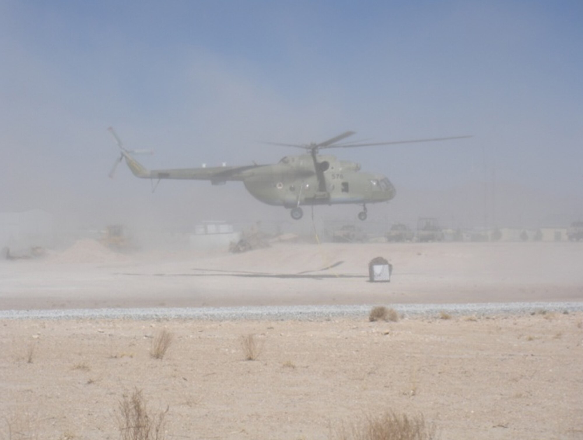 An Afghan Air Force Mi-17 uses a sling to carry cargo at Kandahar Airfield. AAF pilots and aircrew members were taught an aircrew coordination training class May 14 at Kandahar Airfield. The ACT class is a three-part course that is designed to help improve the communication between pilots and their crews. (U.S. Air Force courtesy photo)
