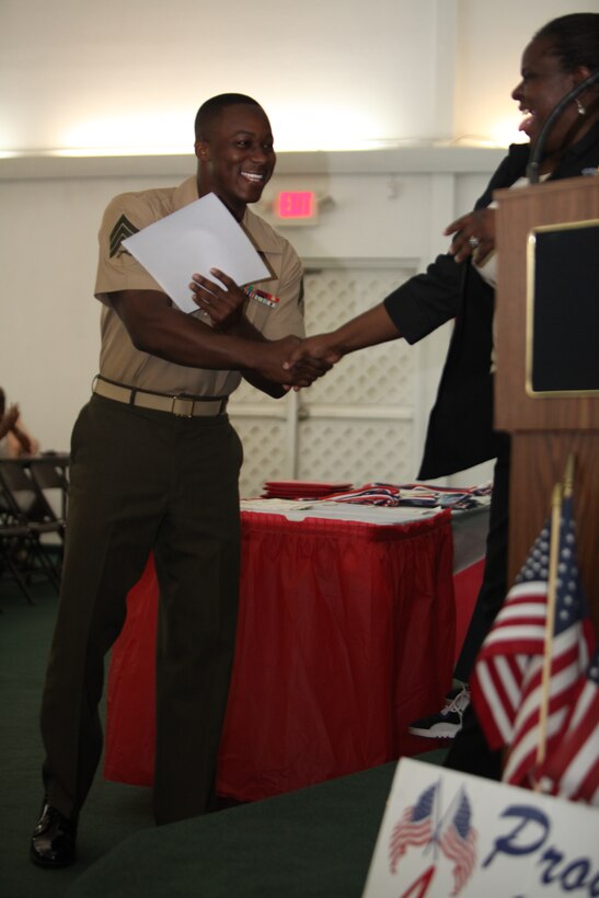 Sgt. Warren Bernard, a supply noncommissioned officer with Marine Forces Reserve, accepts an award for volunteering at the West Bank Community School May 18.  Bernard and a few other Marines have been volunteering since October 2010.