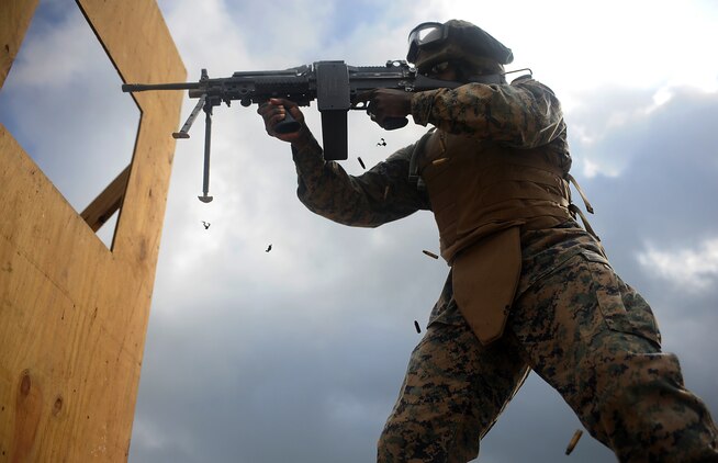 Lance Cpl. Marcus Terry fires the M-249 Squad Automatic Weapon through a mock window on an unknown distance course at Marine Corps Base Quantico, Va., May 18. Terry is an infantryman assigned to the Grounds Combat Element, Marine Barracks Washington.