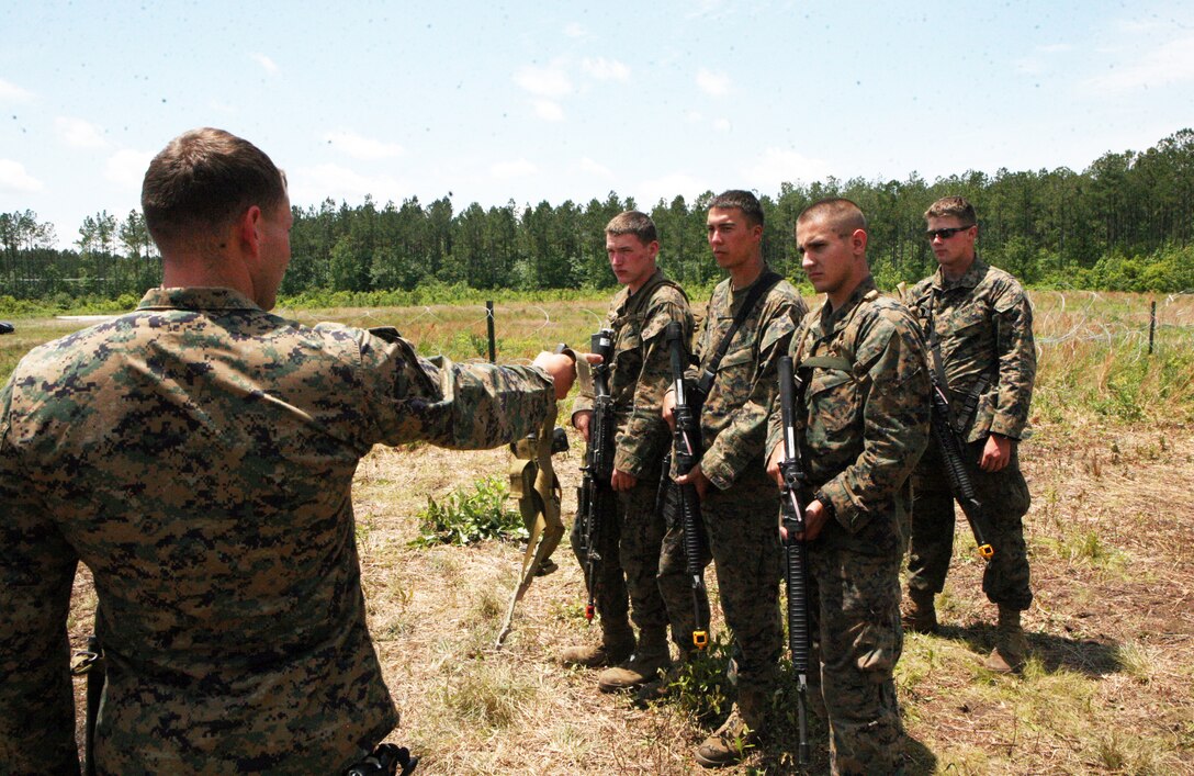 Marines with Military Police Company, Combat Logistics Regiment 27, 2nd Marine Logistics Group, perform personal security detail exercises during a training exercise at Landing Zone Flamingo aboard Camp Lejeune, N.C., May 19, 2011.  The company performed several exercises during the training event such as close quarter combat, air medical evacuations, personal security detail and convoy security. (U.S. Marine Corps photo by Pfc. Franklin E. Mercado)