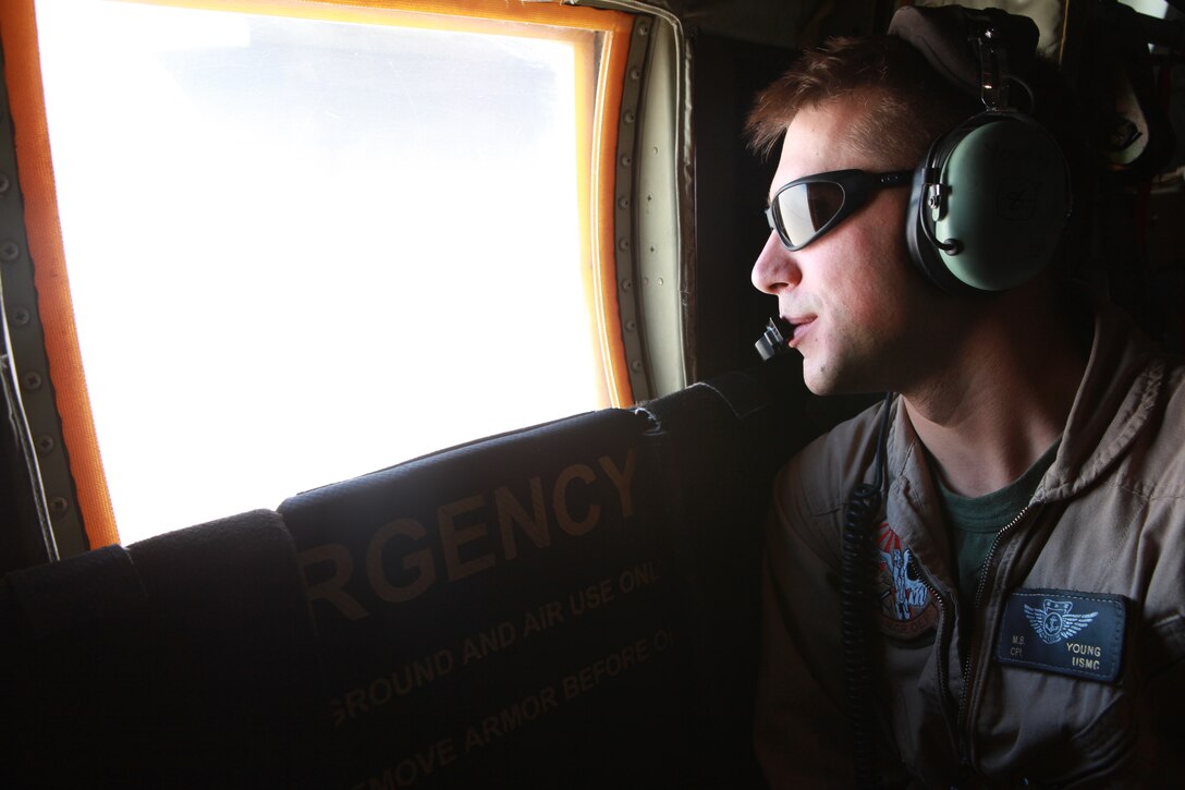 Cpl. Matt B. Young, a crew chief with Marine Aerial Refueler Squadron 252, and a native of Cannon Falls, Minn., looks out the window of a KC-130J during an aerial refueling operation in support of Marine Fighter Attack Squadron 122 in southwestern Afghanistan, May 19. VMGR-252, a KC-130J Hercules squadron deployed out of Marine Corps Air Station Cherry Point, N.C., to Afghanistan’s Kandahar Airfield, supports U.S. Marines, Afghan forces and other coalition troops by providing aerial refueling, evening battlefield illumination, and transporting cargo and troops in Afghanistan’s Nimroz and Helmand provinces and beyond.
