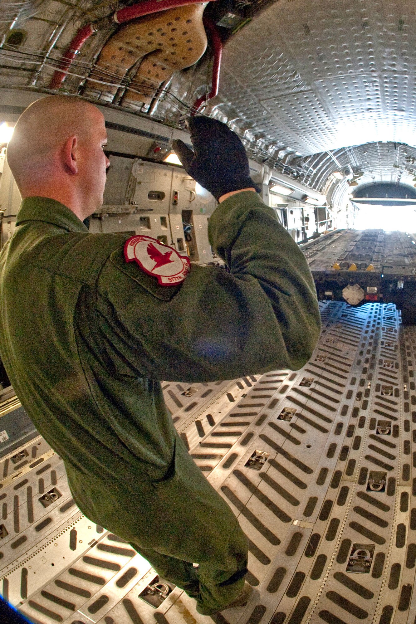 C-17 Globemaster III load master Senior Airman Jeff Purvis, 517th Airlift Squadron, guides a Halvorsen loader into C-17’s cargo bay during a practice load for the Air Mobility Command RODEO 2011. (Photo by Steve White/JBER PA) (U.S. Air Force photo\Steve White)