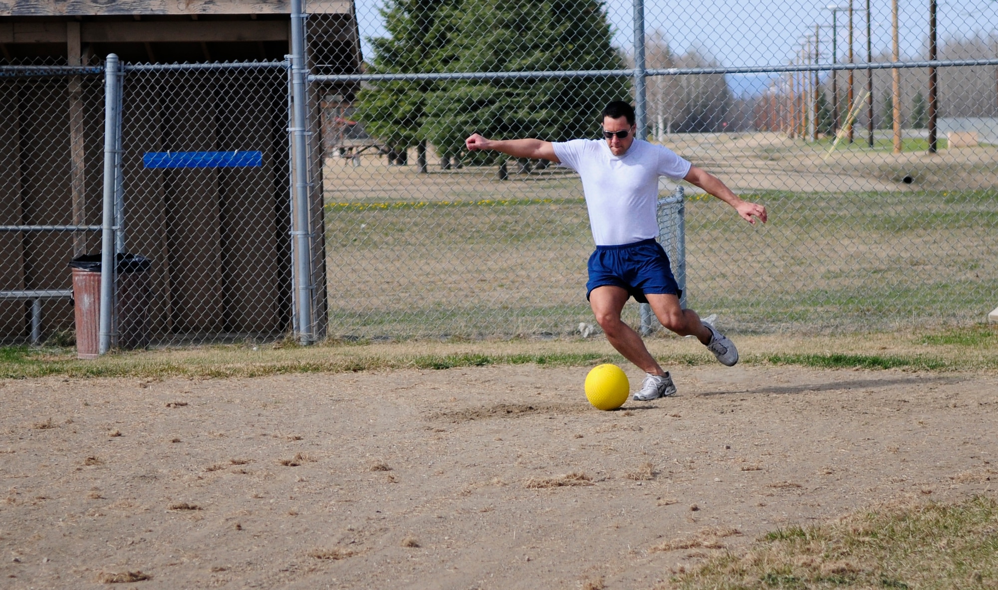 Senior Airman Nikolas Coleman strikes a kickball during a squadron physical training session May 17, 2011, Eielson Air Force Base, Alaska.  The warmer weather allows the 354th Comptroller Squadron and other units  to  move  the squadron's weekly workout outdoors.  Airman Coleman is a budget analyst assigned to the 354th CPTS.  (U.S. Air Force photo/Airman 1st Class Yash Rojas)