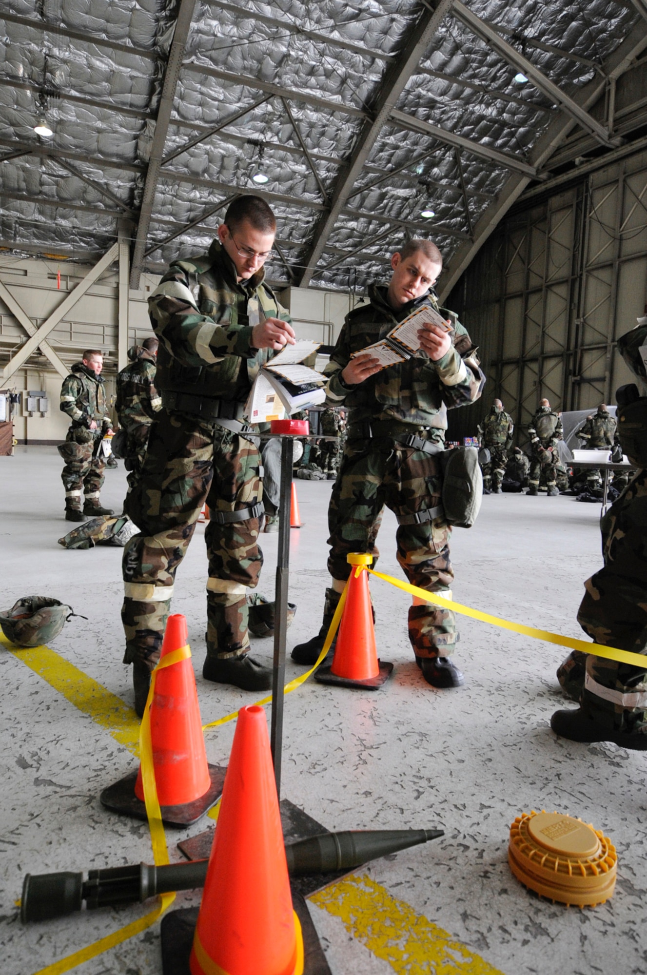 SrA Robin O'Brian and A1C Joshua Gilmore,962 AACS, assigned to Joint  Base Elmendorf-Richardson, Anchorage, Alaska, practice unexploded ordinance identifing, reporting, and marking. (U.S. Air Force photo/Steve White)