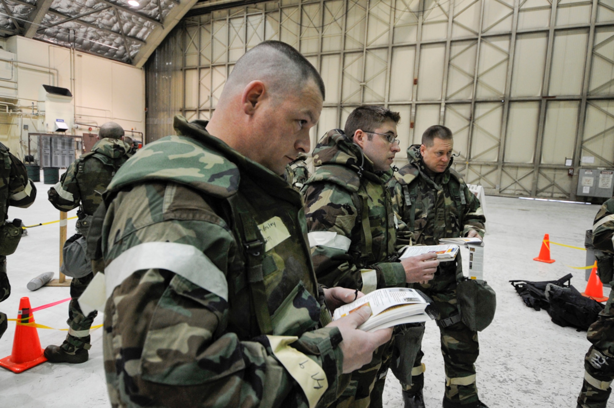 TSgt Barcley Stevens, 3 EMS, reviews Airmans Handbook for proper name of UXO during Ability to Survive and Operate Training at Joint Base Elmendorf-Richardson, Anchorage, Alaska assigned to Joint  Base Elmendorf-Richardson, Anchorage, Alaska. (U.S. Air Force photo/Steve White)