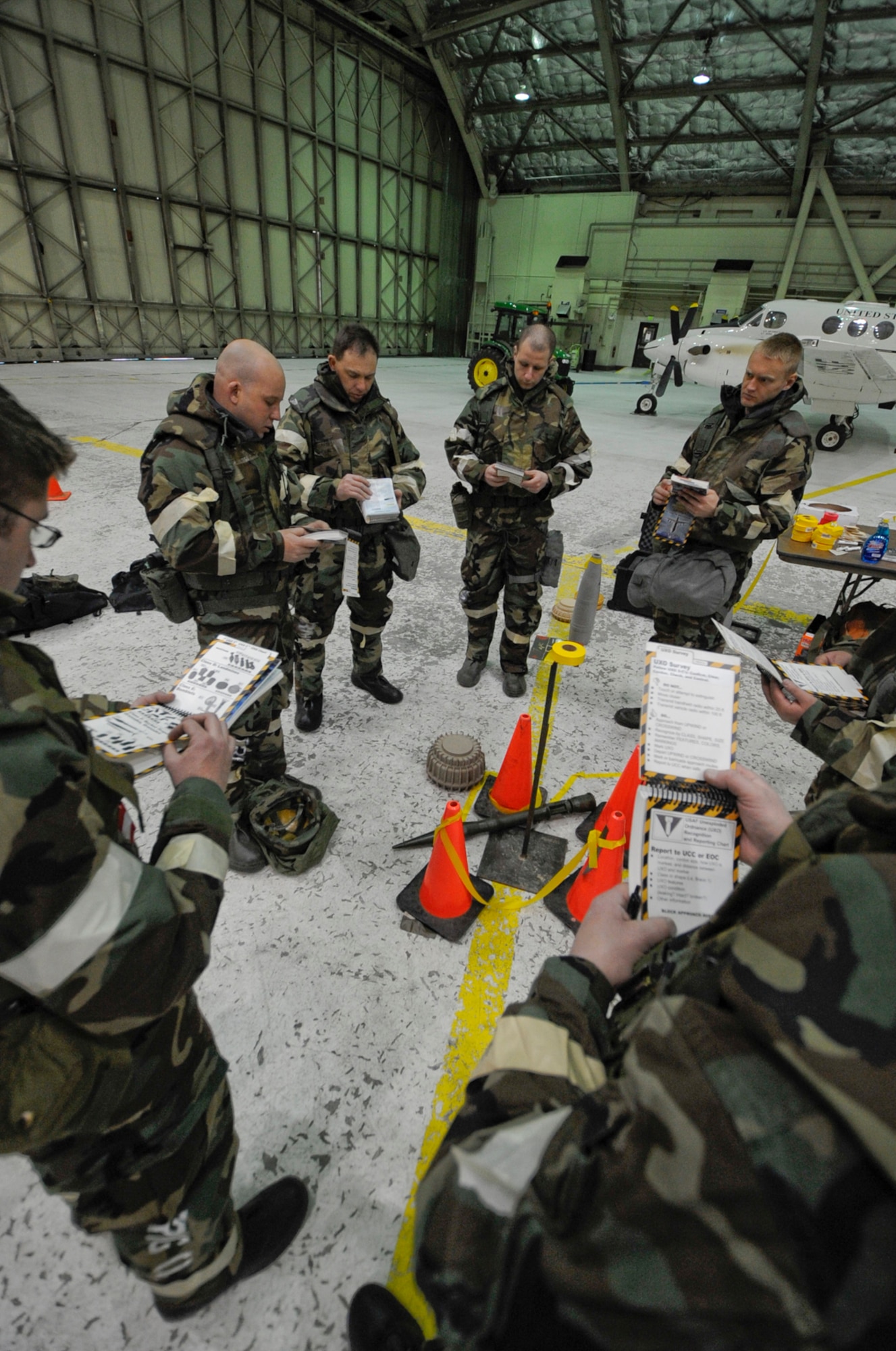 Airmen assigned to Joint  Base Elmendorf-Richardson, Anchorage, Alaska, receive Ability to Survive and Operate Training , practice identifing and reporting and marking unexploded ordinance. (U.S. Air Force photo/Steve White)