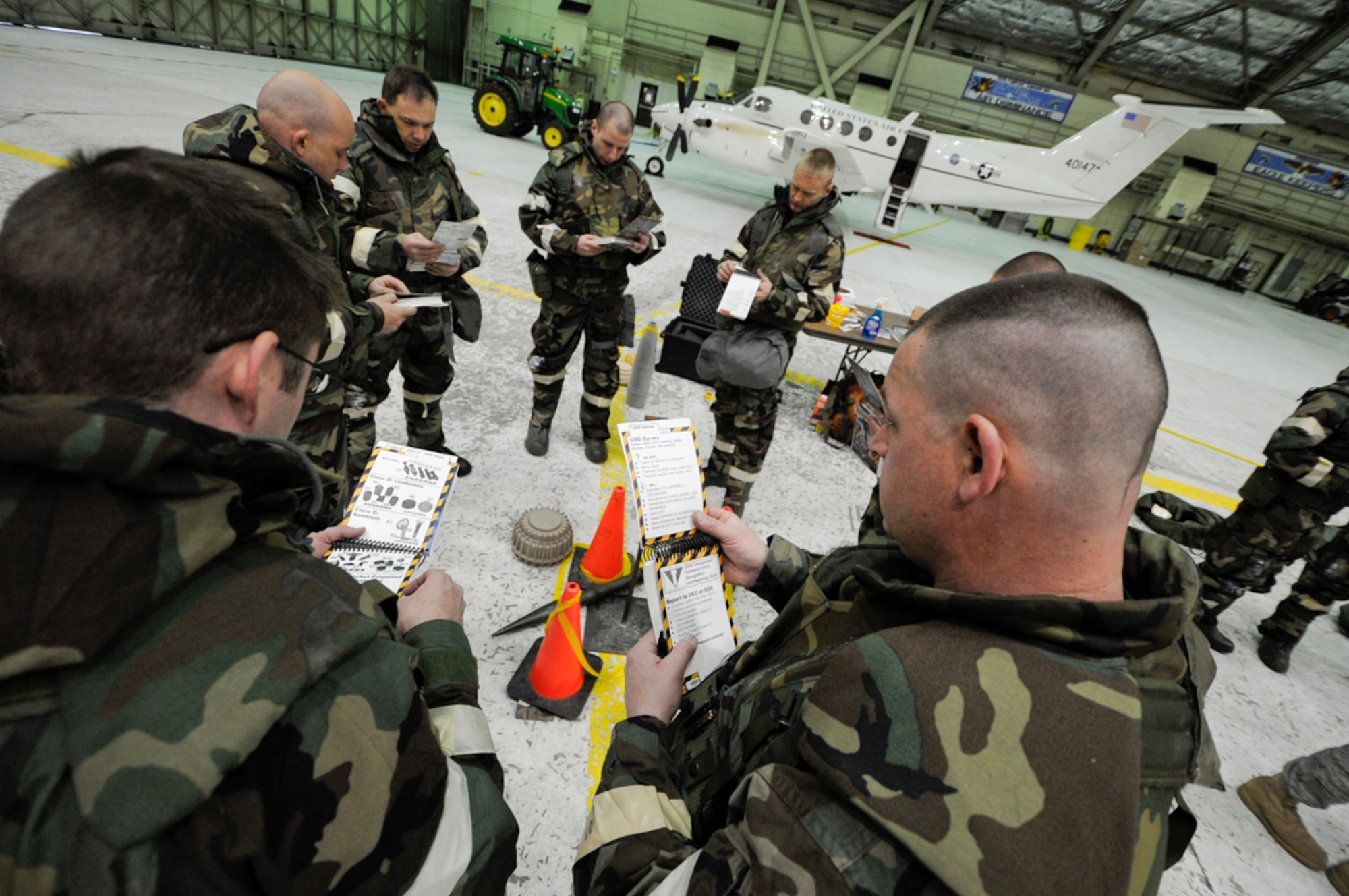 Members of the 673 ABW, go through UXO identifying, marking, and reporting  during Ability to Survive and Operate Training at Joint Base Elmendorf-Richardson, Anchorage, Alaska assigned to Joint  Base Elmendorf-Richardson, Anchorage, Alaska. (U.S. Air Force photo/Steve White)