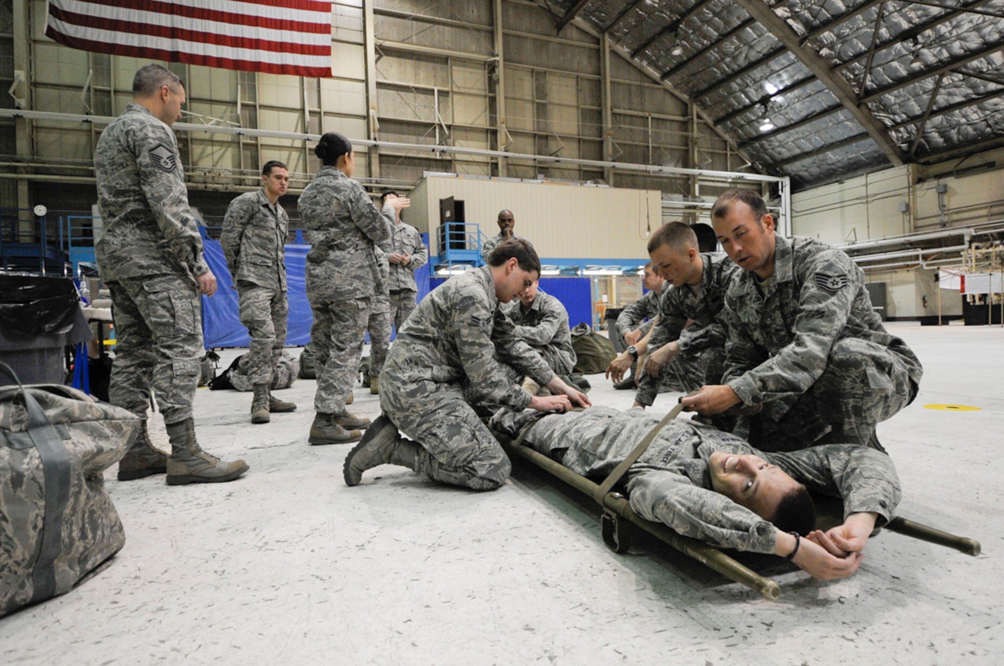 Members of the 673 ABW practice strecher carry procedures with a willing wounded role player during Ability to Survive and Operate Training at Joint Base Elmendorf-Richardson, Anchorage, Alaska assigned to Joint  Base Elmendorf-Richardson, Anchorage, Alaska. (U.S. Air Force photo/Steve White)