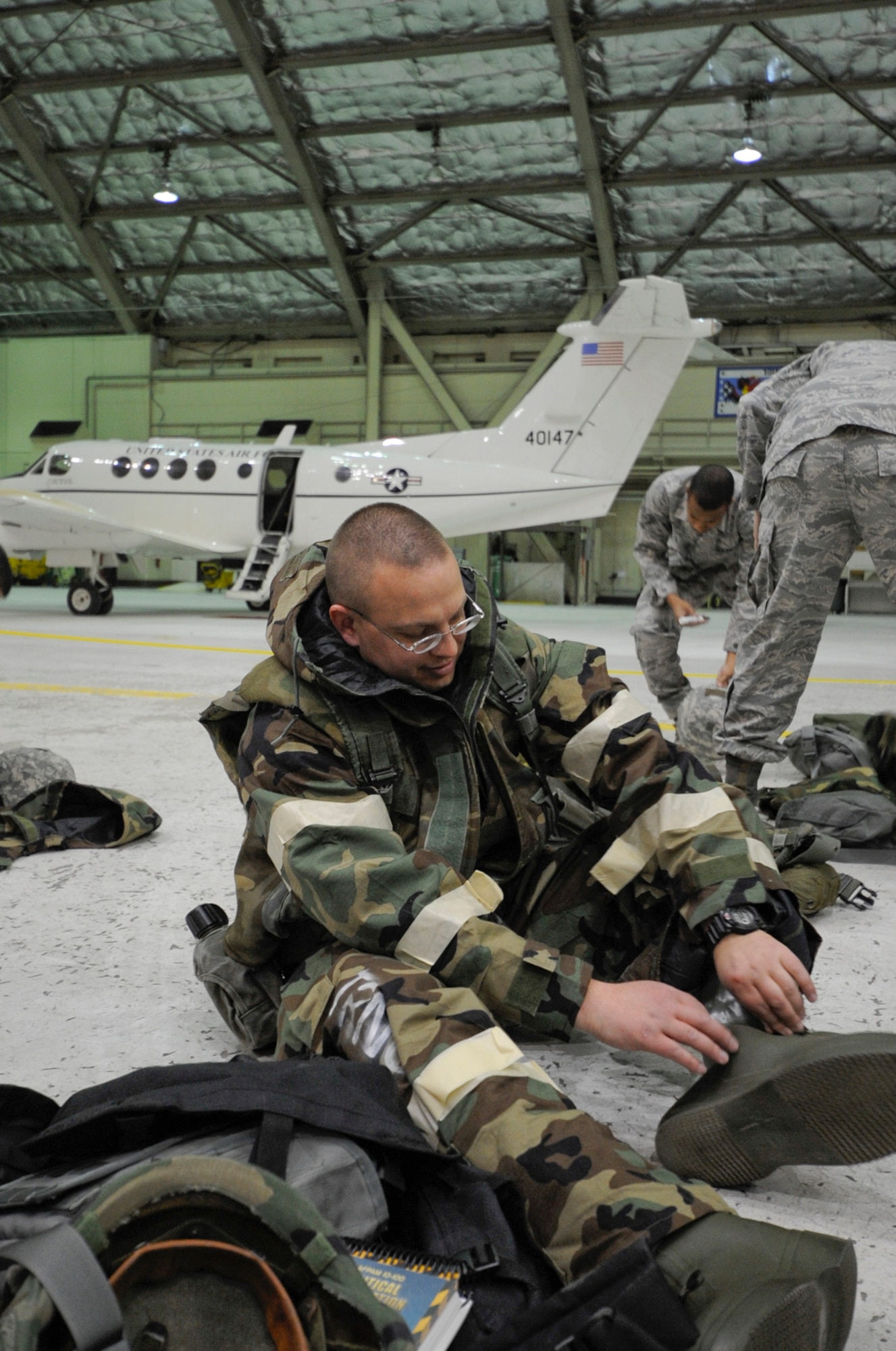 SSgt Kandice Norton, 673 ABW/CEX,, checks mask fit  during trainng for airmen assigned to Joint  Base Elmendorf-Richardson, Anchorage, Alaska, in preparation for a Phase 2 exercise. (U.S. Air Force photo/Steve White)