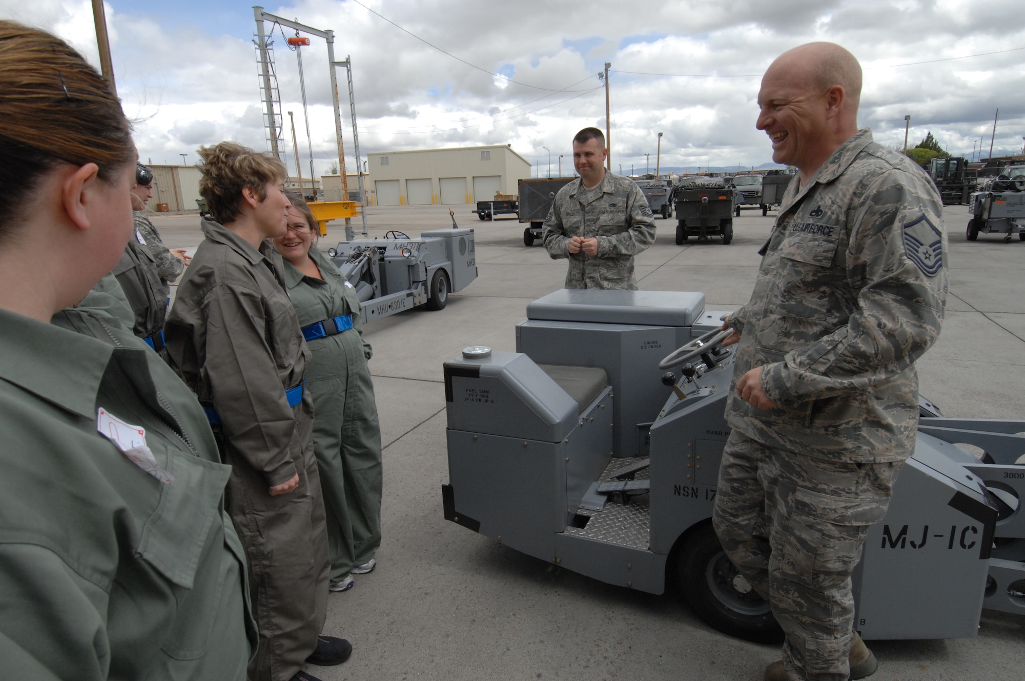 MOUNTAIN HOME AIR FORCE BASE, Idaho – Master Sgt. Jason J. Roberts, 391st Aerospace Ground Equipment team leader, jokes with senior leadership spouses while explaining the unique capabilities of the MHU-83 Jammer here May 16. The spouses were introduced to two different types of Jammers during the presentation. (U.S. Air Force photo by Senior Airman Benjamin Sutton) 