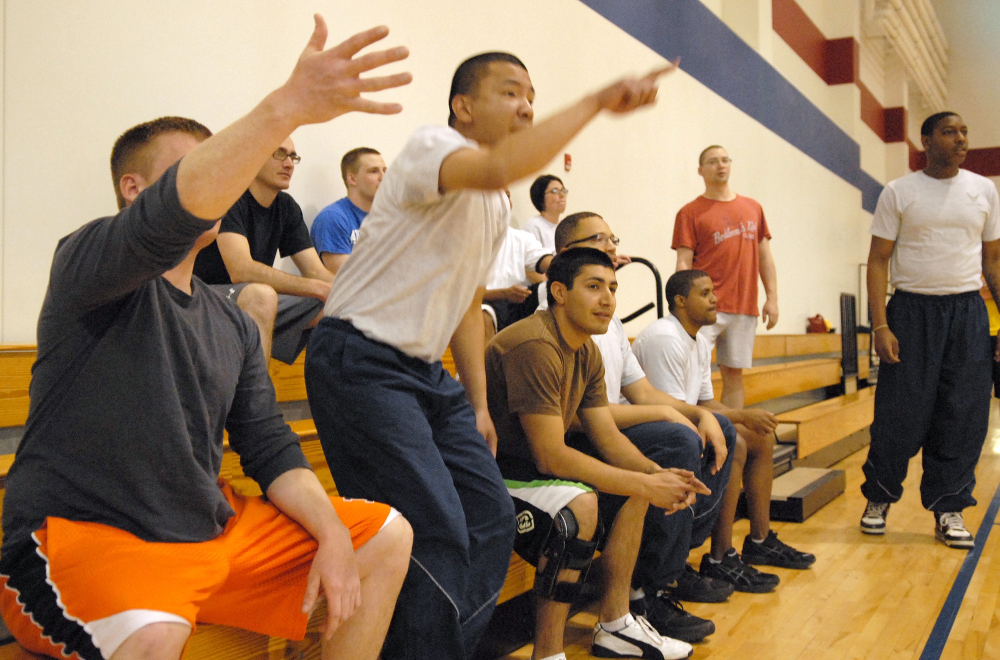 Supporters of one of the 90th Logistics Readiness Squadron dodge ball teams reacts to the action during the dodge ball tournament part of the fitness day held at Freedom Hall Fitness Center Wednesday. (U.S. Air Force photo by R.J. Oriez)