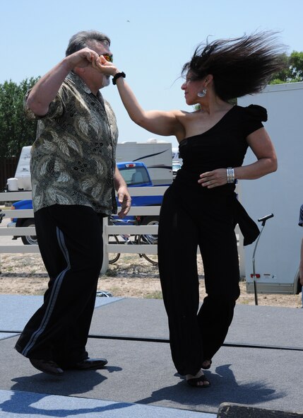 LAUGHLIN AIR FORCE BASE, Texas – A couple demonstrates salsa dancing on stage during Laughlin’s diversity-themed wing picnic here May 13. A variety of ethnic foods were available for sample and bands played throughout the afternoon while more than 2,300 Laughlin members turned out to take it all in. (U.S. Air Force photo by Airman 1st Class Blake Mize)