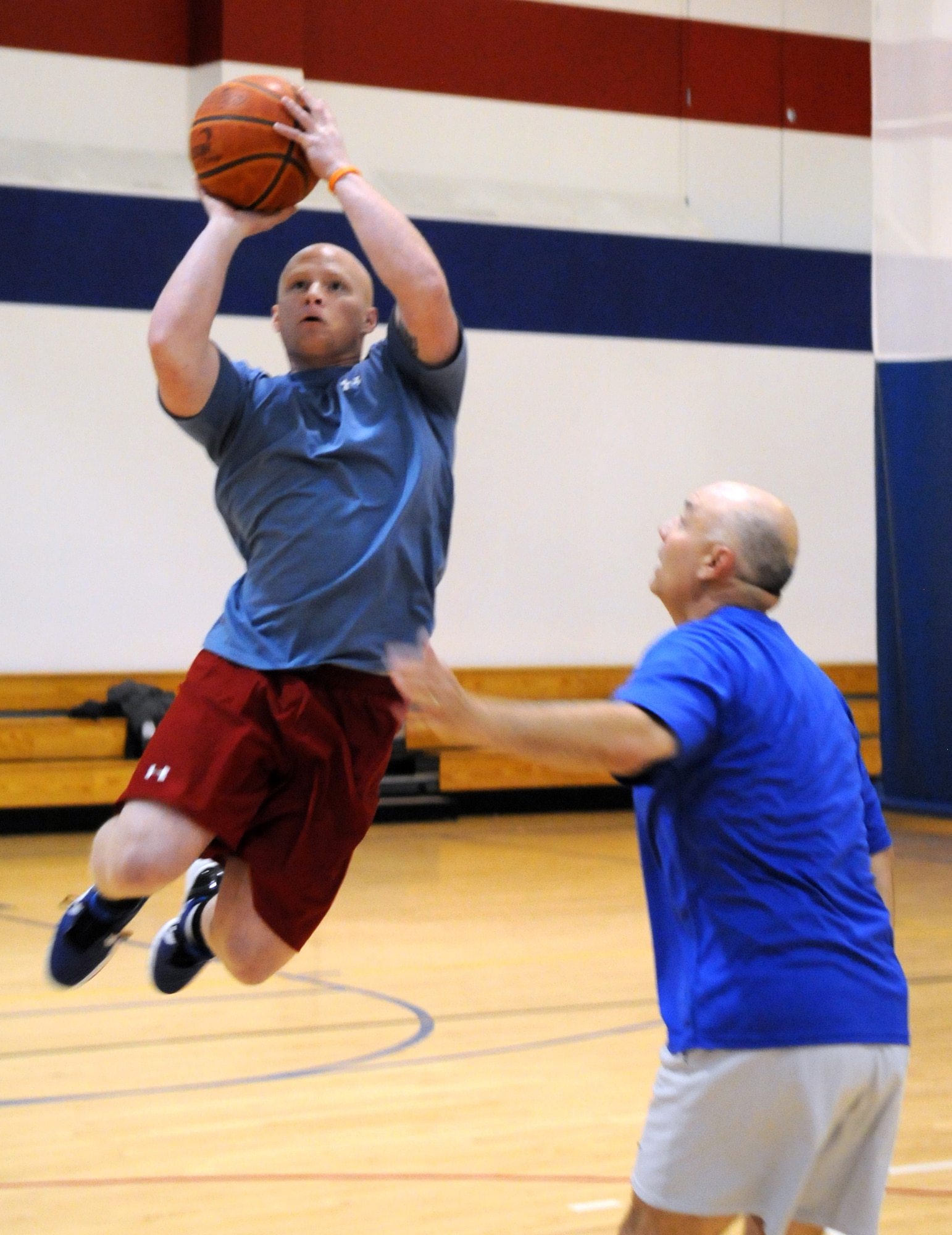 Dirty 30’s Airman 1st Class Danny Wilks , 30th AS, goes up for a shot against the No Name’s Maj. Alan Chouest, 90th MW chaplain, during their 3-on-3 basketball game as part of Fitness Day at Freedom Hall Wednesday, May 11. (U.S. Air Force photo by R.J. Oriez)