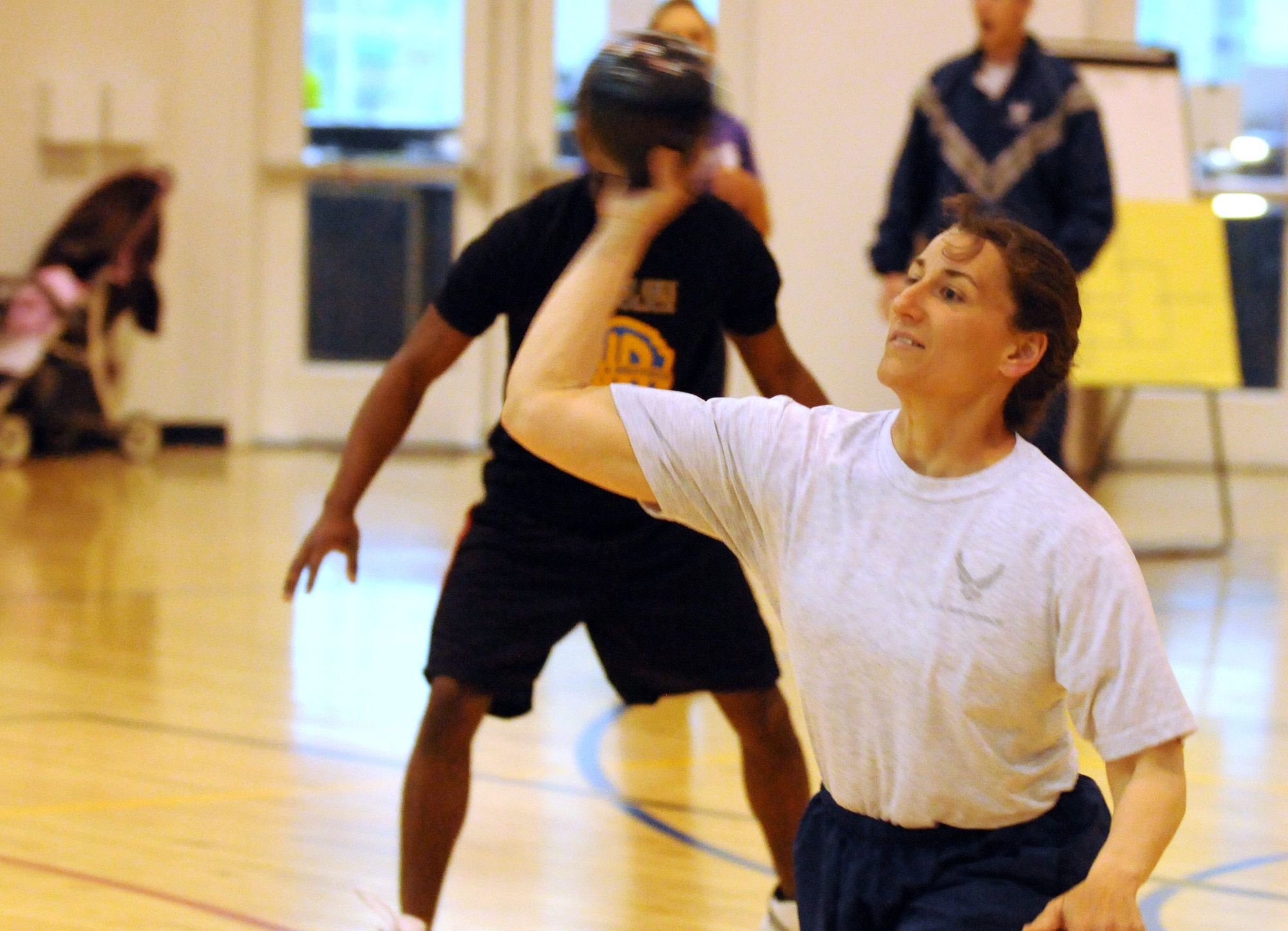 Master Sgt. Jeanine Steele, 90th Logistics Readiness Squadron, takes aim at the competition during  the dodge ball tournament part of the fitness day held at Freedom Hall Fitness Center May 11. (U.S. Air Force photo by R.J. Oriez)