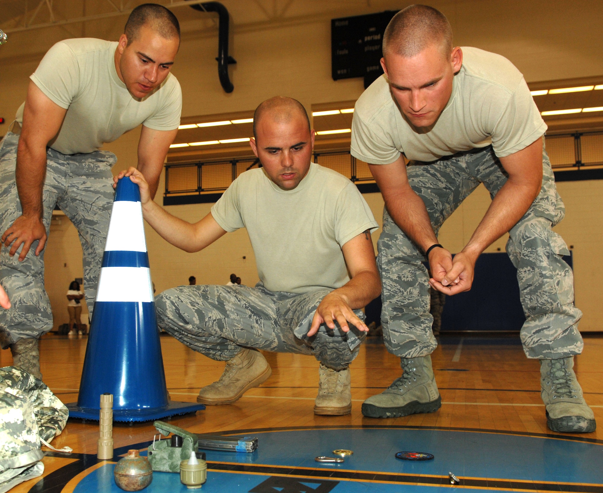 Senior Airman Tyler Wiseman, Staff Sgt. David Garver and Airman 1st Class Steven Barnosky, 633d Security Forces Squadron canine handlers, compete in the keep in memory challenge during the 633d Security Forces Squadron Strong Team Competition at Langley Air Force Base, Va., May 18, 2011. The competition was held as part of National Police Week , an annual event held to remember fallen defenders, both military and civilian. (U.S. Air Force photo by Staff Sgt. Jeff Nevison)(RELEASED)