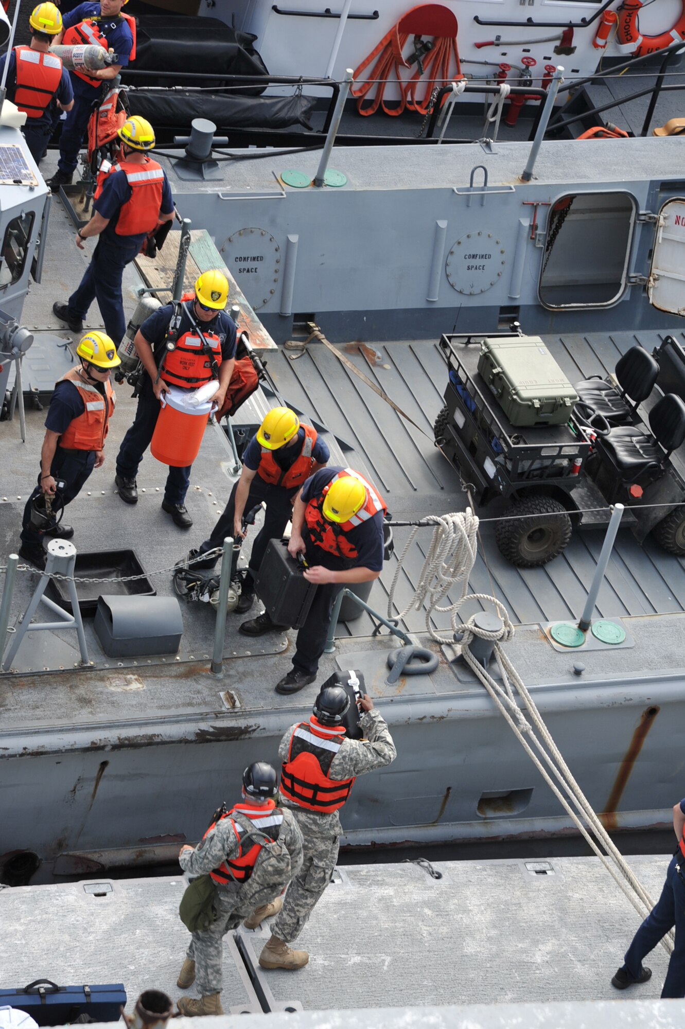Local first responders pass equipment onto the "Cape Johnson" during the first day of the Hampton Roads Full Scale Exercise staged off the coast of Fort Eustis, Va., May 17, 2011. The three day exercise strengthens anti-terrorism capabilities and tests local, state and federal response efforts in maritime, hostage and mass casualty scenarios. (U.S. Air Force photo by Airman 1st Class Camilla Griffin) (RELEASED)