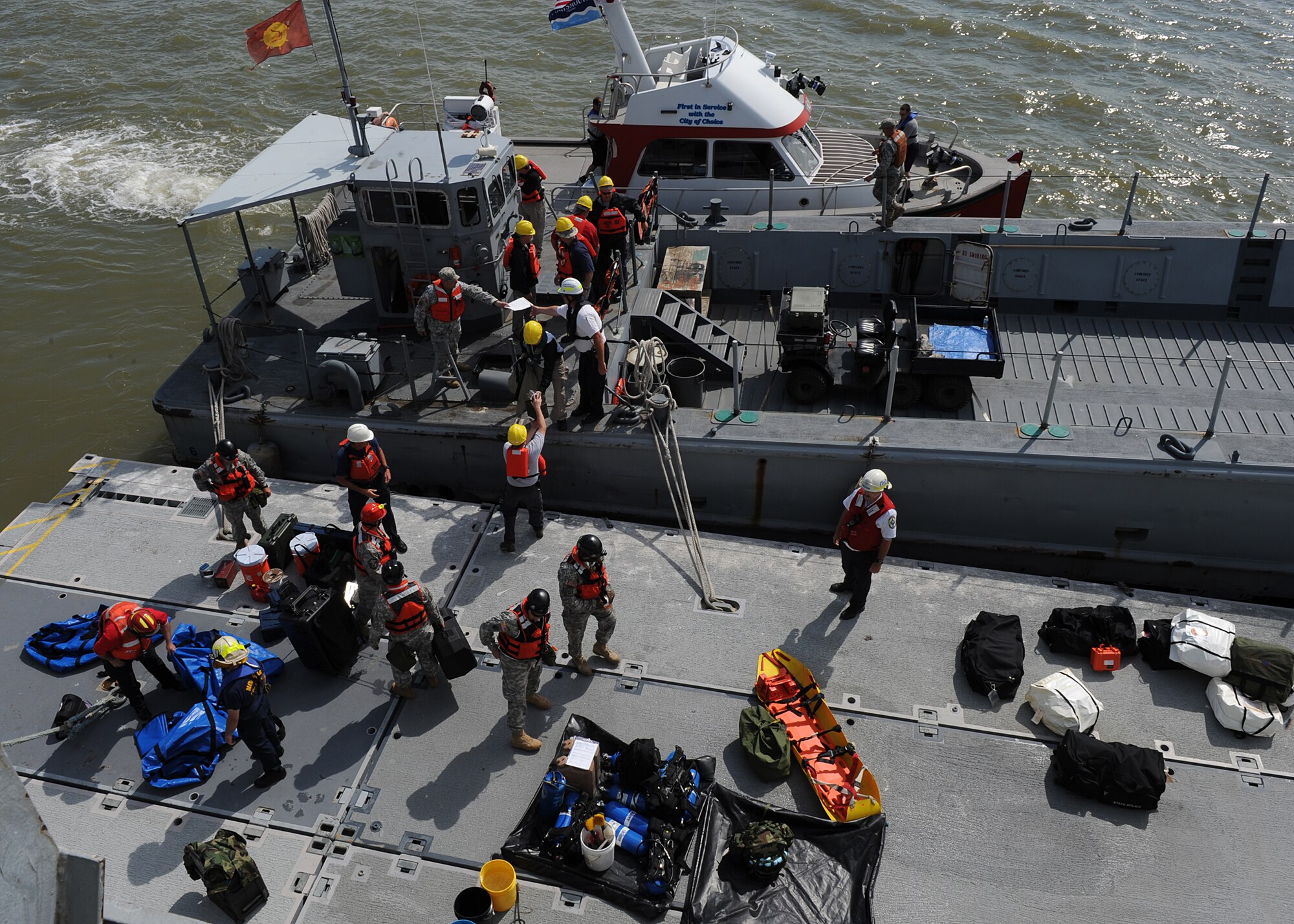 Local first responders gather Hazardous Material equipment before boarding the "Cape Johnson", the site for the first day of the Hampton Roads Full Scale Exercise staged off the coast of Fort Eustis, Va., May 17, 2011. The three day exercise strengthens anti-terrorism capabilities and tests local, state and federal response efforts in maritime, hostage and mass casualty scenarios. (U.S. Air Force photo by Senior Airman Zachary Wolf)(RELEASED)