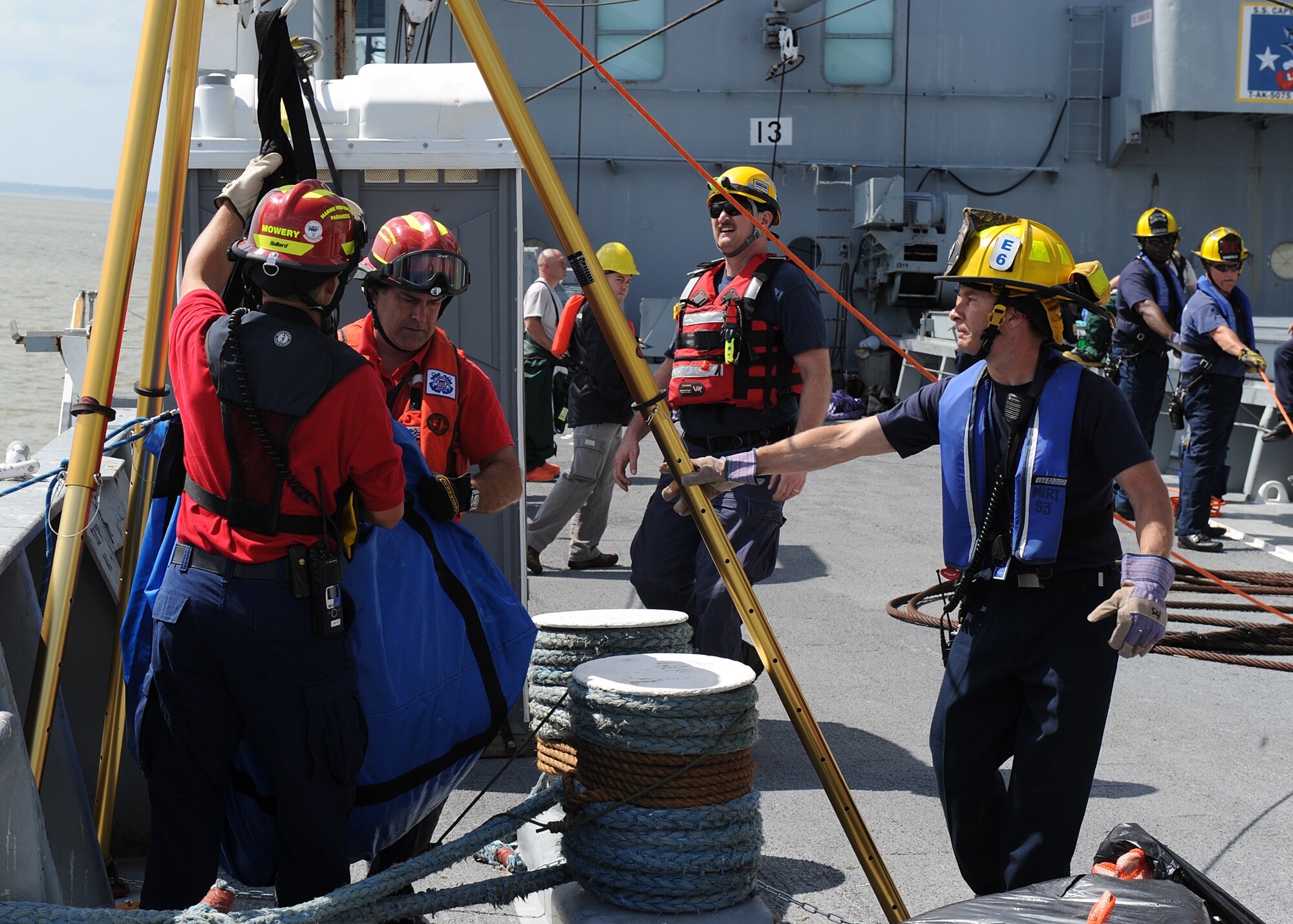 Firefighters unload Hazardous Material equipment on board the "Cape Johnson" during the first day of the Hampton Roads Full Scale Exercise staged off the coast of Fort Eustis, Va., May 17, 2011. The three day exercise strengthens anti-terrorism capabilities and tests local, state and federal response efforts in maritime, hostage and mass casualty scenarios.  (U.S. Air Force photo by Senior Airman Zachary Wolf)(RELEASED)