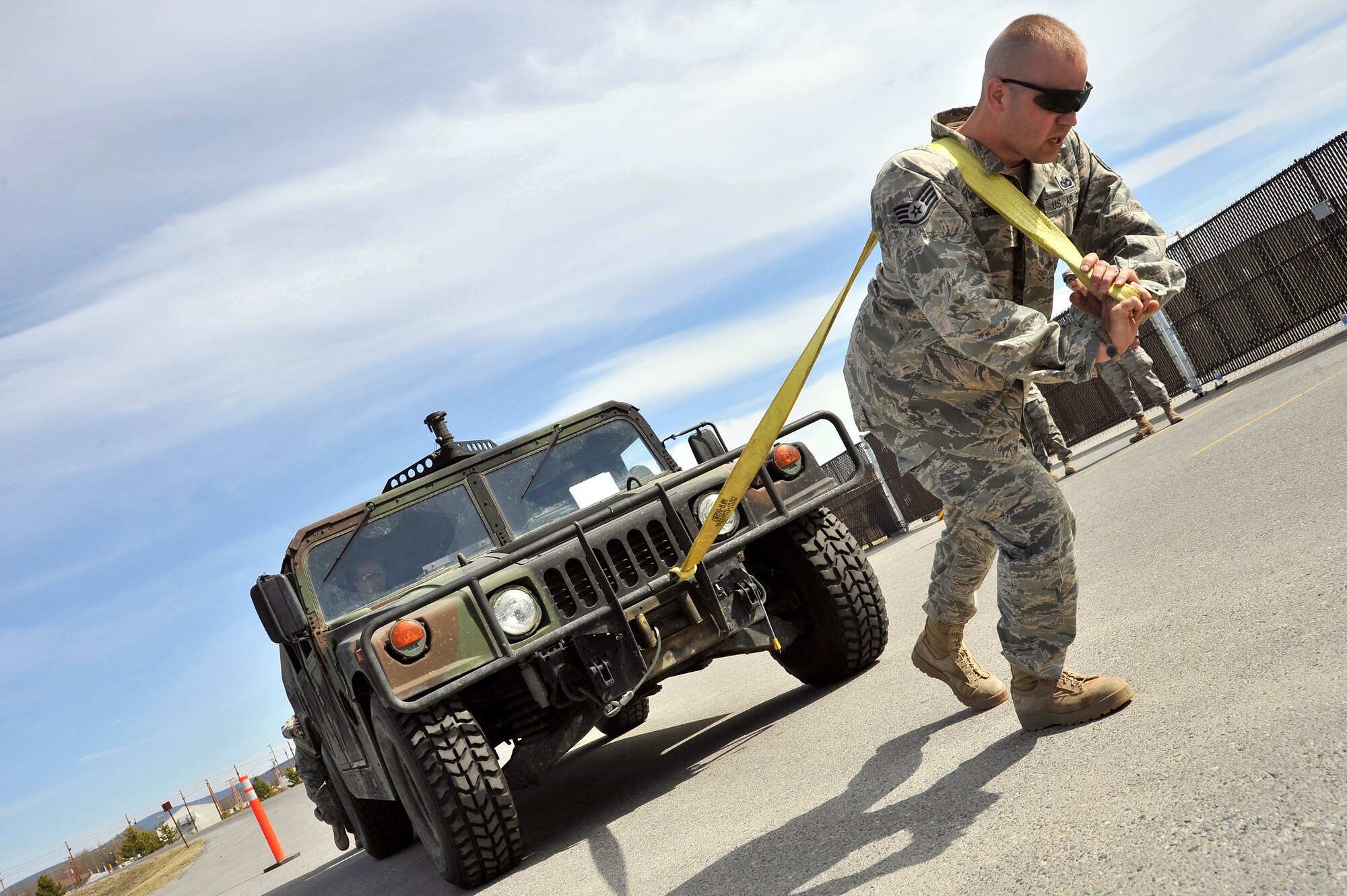 Staff Sgt. Steven Brown pulls a Humvee towards the finish line of the Security Forces warrior challenge during National Police Week May 17, 2011, Eielson Air Force Base, Alaska. The warrior challenge consisted of pushups, a 40-pound ruck march, a litter carry and Humvee pull. National Police Week is celebrated across the U.S.  and abroad by Security Forces units to commemorate and honor those who serve as law enforcement officers. Sergeant Brown is the unit deployment manager assigned to the 354th Security Forces Squadron. (U.S. Air Force photo/Staff Sgt. Christopher Boitz)