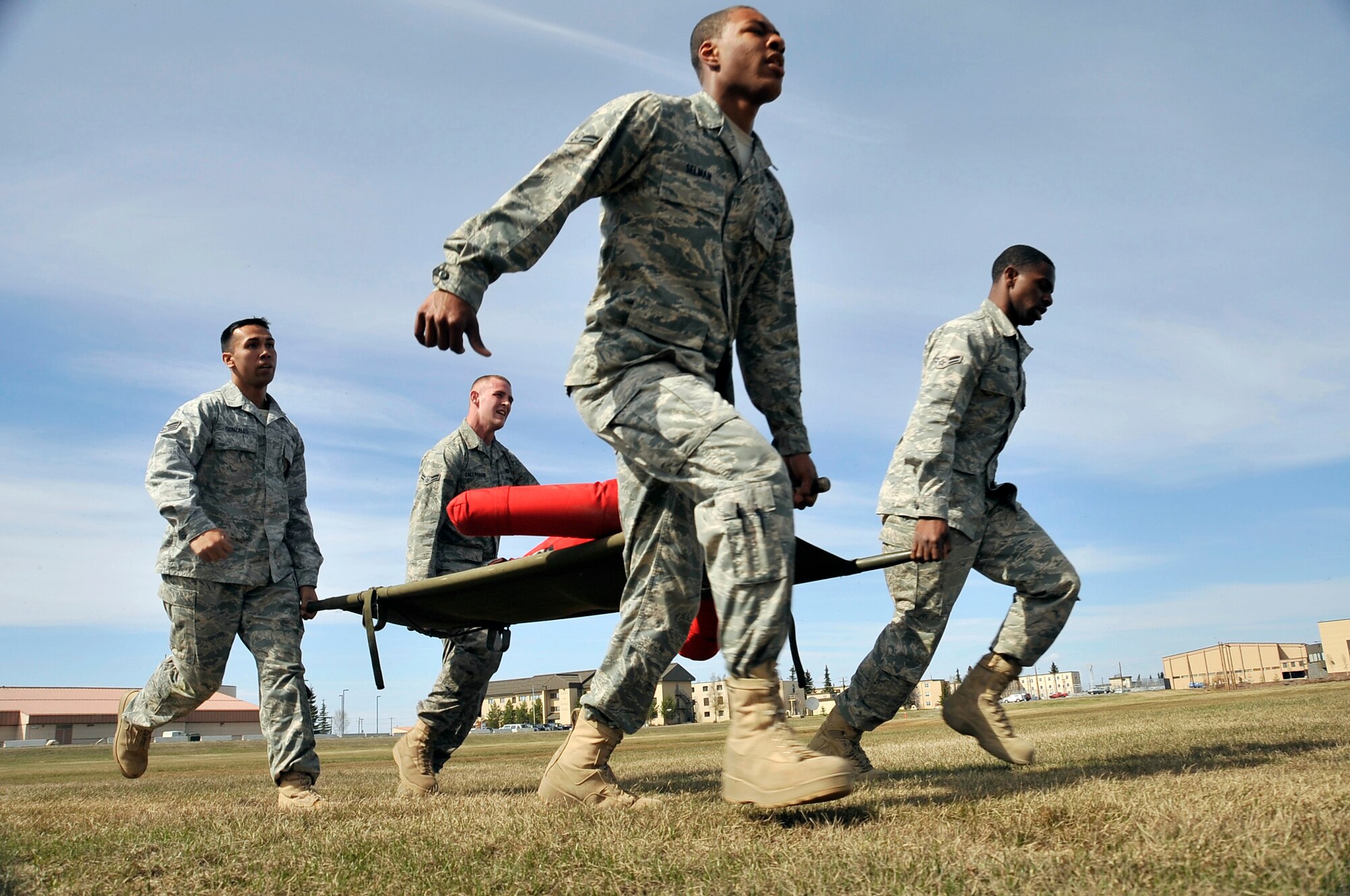 354th Security Forces Squadron members perform a litter carry using a dummy in the SF warrior challenge during National Police Week May 17, 2011, Eielson Air Force Base, Alaska. The warrior challenge consisted of pushups, a 40-pound ruck march, a litter carry and Humvee pull. National Police Week is celebrated across the U.S.  and abroad by Security Forces units to commemorate and honor those who serve as law enforcement officers.  (U.S. Air Force photo/Staff Sgt. Christopher Boitz)