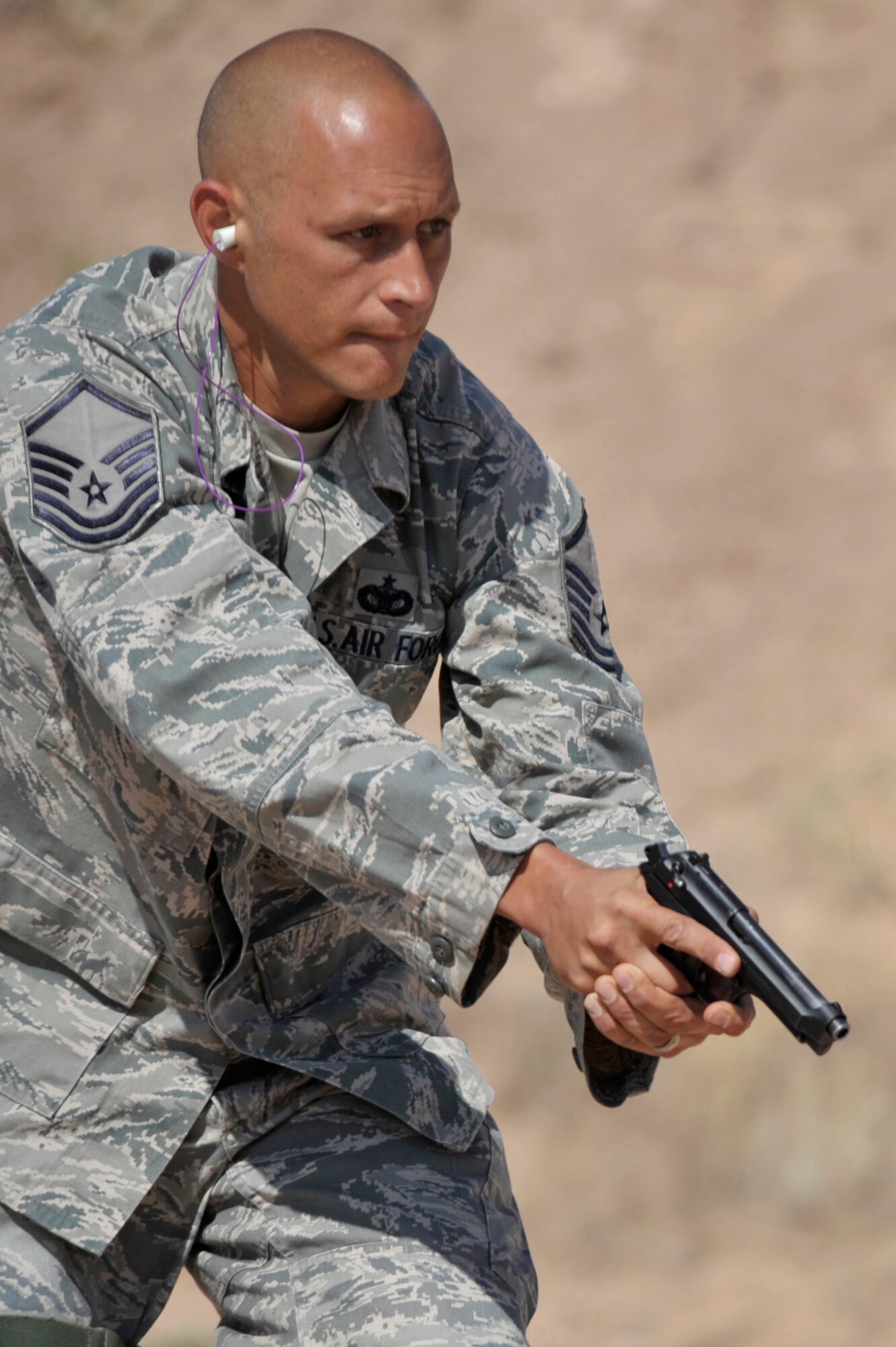 Master Sgt. Darrel Bailey, 27th Special Operations Security Forces Squadron, prepares to run through the shooting course at Patriot Outdoors in Clovis, N.M., May 16, 2011. The shooting course was one of the many activities organized to support Police Week, a week set aside to honor all those who serve in law enforcement. (U.S. Air Force photo by Airman Ericka Engblom)