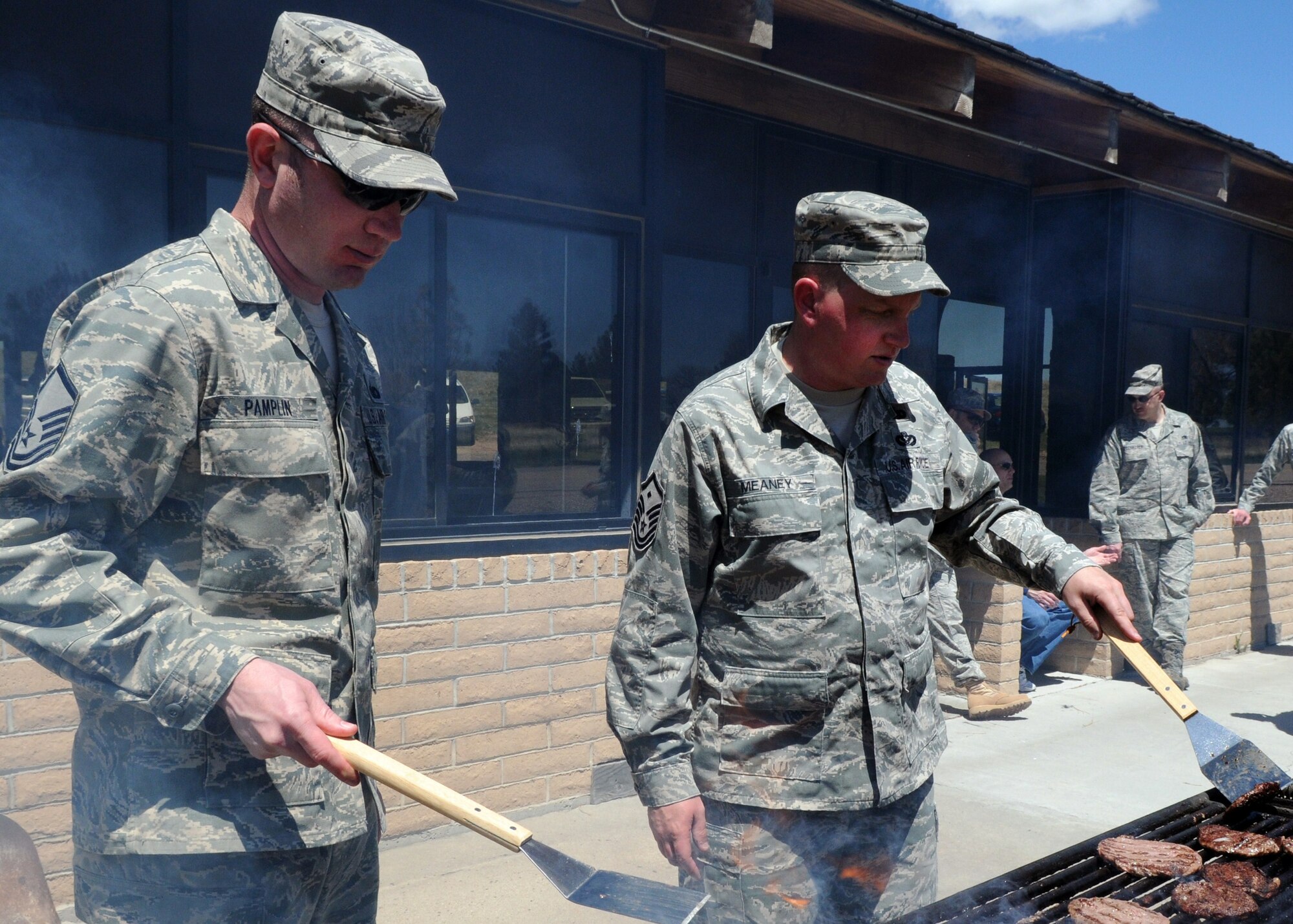 Master Sgts. James Pamplin and Todd Meaney grill hamburgers for the Airman Appreciation Barbecue sponsored by the First Sergeants’ Council at the base lake pavilion Friday, May 13. “We’ve done it every year, but we’re going to try to do it more often,” Sergeant Meaney, council president, said. “This is for Airmen, with a big ‘A’, to thank all our Airmen for what they do every day.” (U.S. Air Force photo by R.J. Oriez)