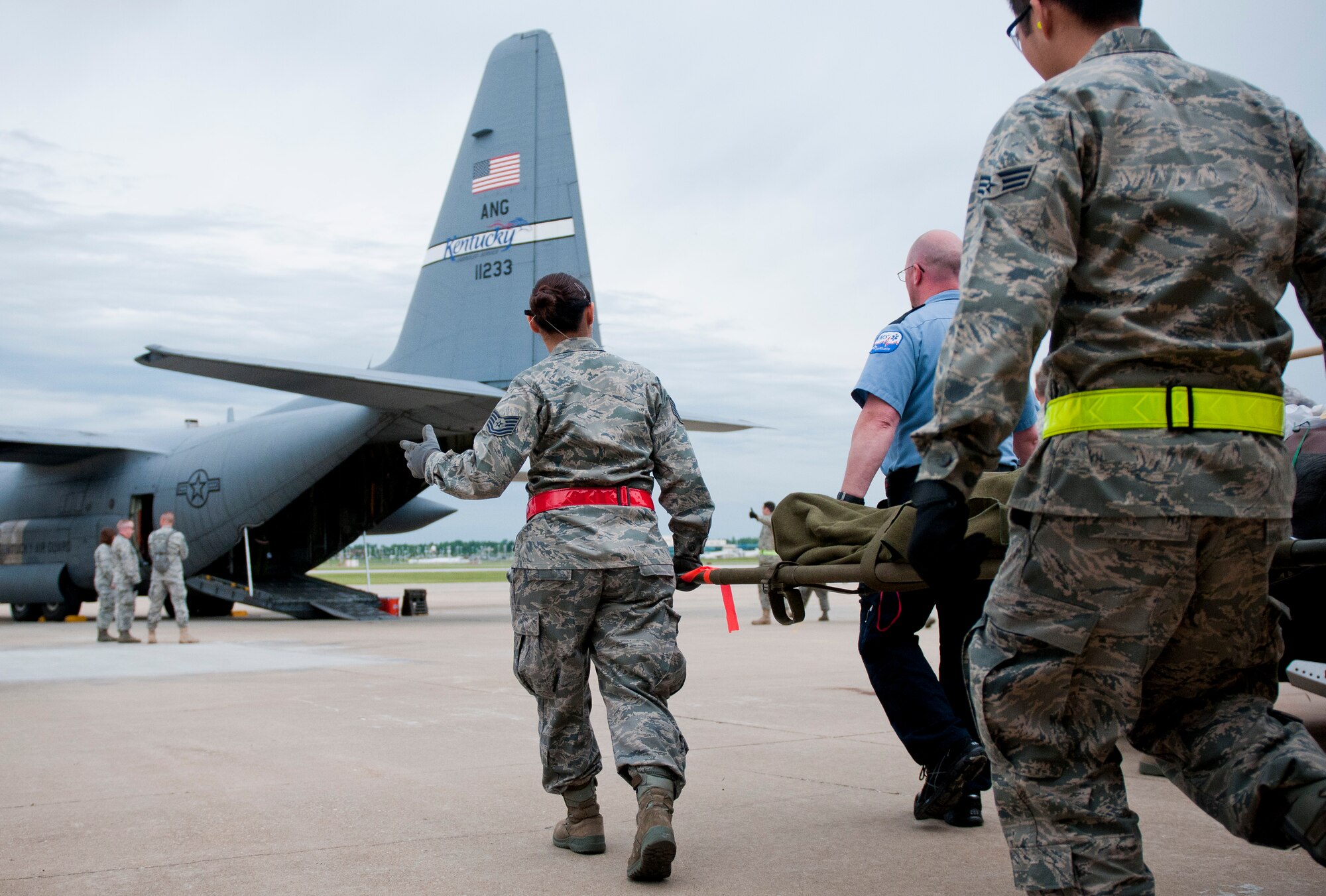 Airmen from Scott Air Force Base, Ill., Travis Air Force Base, Calif., Pope Air Force Base, N.C., and MacDill Air Force Base, Fla., along with EMTs from CoxHealth in Springfield, Mo., simulate carrying evacuees in need of medical assistance during National Level Exercise 2011 at Springfield-Branson National Airport in Springfield, Mo., on May 18, 2011. The exercise is based on a scenario involving a massive earthquake along the New Madrid fault line, requiring extensive aeromedical evacuation of injured patients. (U.S. Air Force photo by Senior Airman Maxwell Rechel)