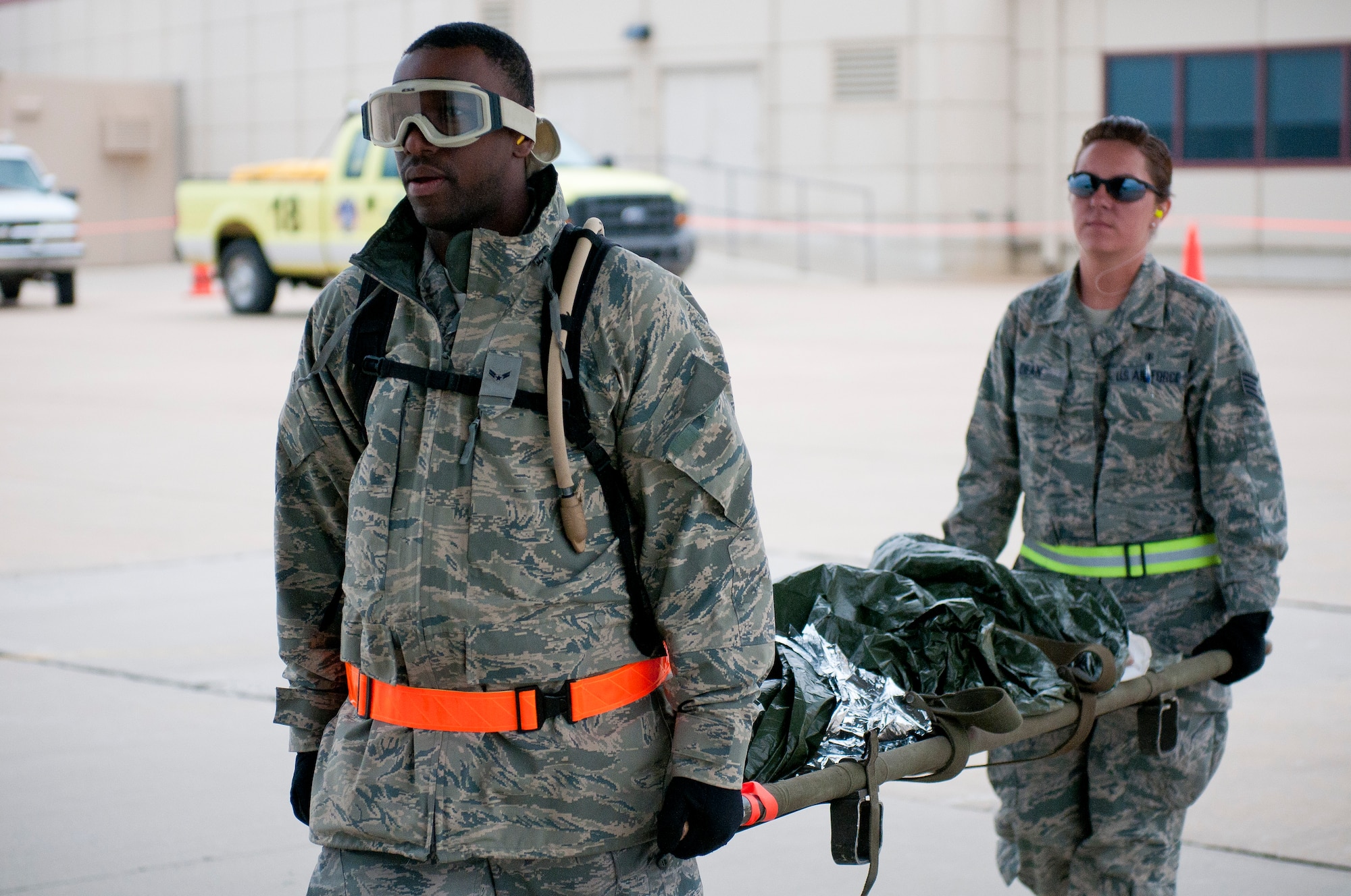 Airman 1st Class Renaldo Maxwell from the 6th Medical Group, MacDill Air Force Base, Fla., and Sgt. Stephanie Dean, 60th Inpatient Operations, Travis Air Force Base, Calif., carry a mannequin into the back of a Kentucky Air National Guard C-130 Hercules at Springfield-Branson National Airport in Springfield, Mo., on May 18, 2011, as part of National Level Exercise 2011. The exercise is based on a scenario involving a massive earthquake along the New Madrid fault line, requiring extensive aeromedical evacuation of injured patients. (U.S. Air Force photo by Senior Airman Maxwell Rechel)