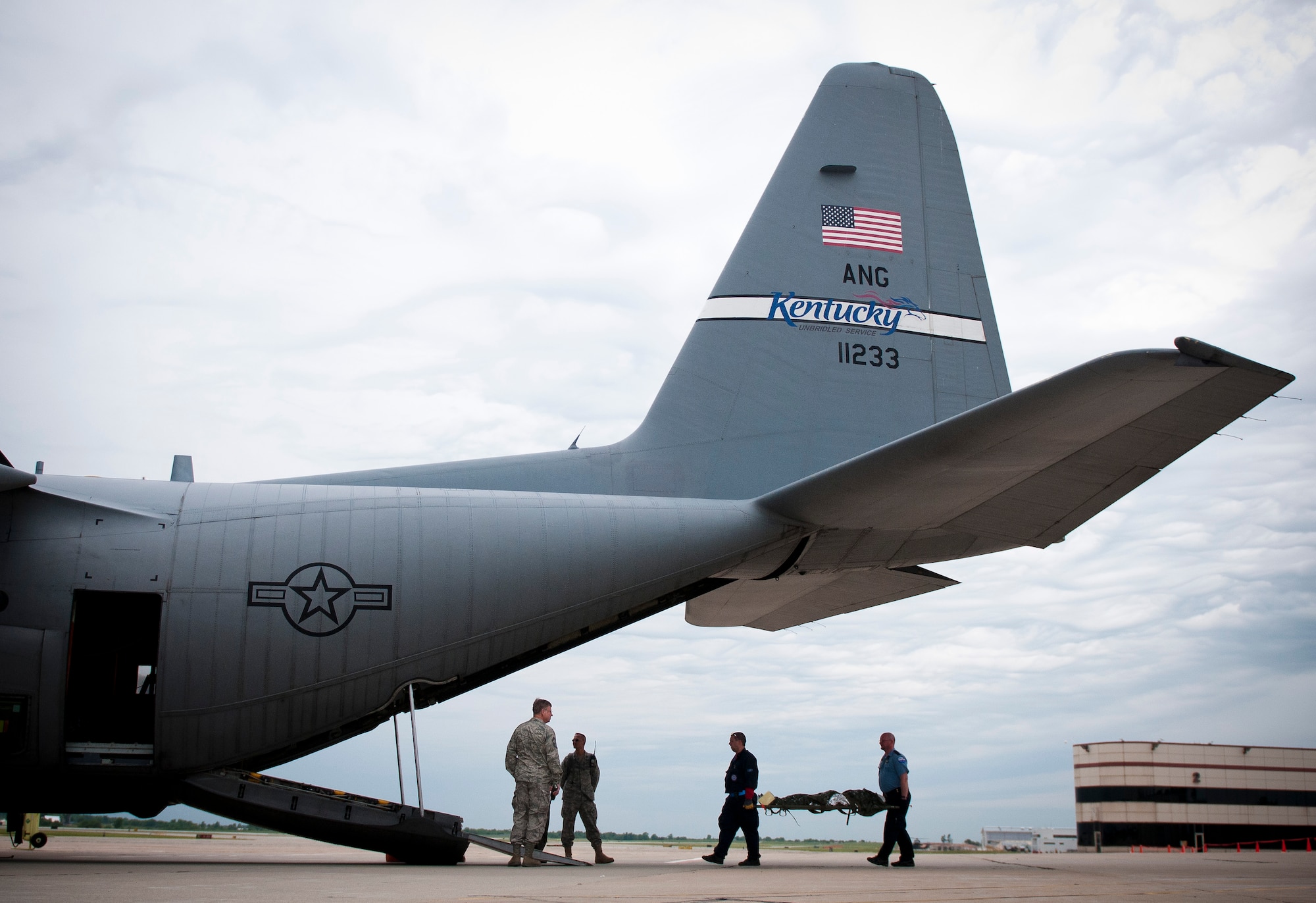 EMTs from CoxHealth of Springfield, Mo., carry a mannequin into the back of a Kentucky Air Guard C-130 at Springfield-Branson National Airport in Springfield, Mo., on May 18, 2011, as part of National Level Exercise 2011. The exercise is based on a scenario involving a massive earthquake along the New Madrid fault line, requiring extensive aeromedical evacuation of injured patients. (U.S. Air Force photo by Senior Airman Maxwell Rechel)