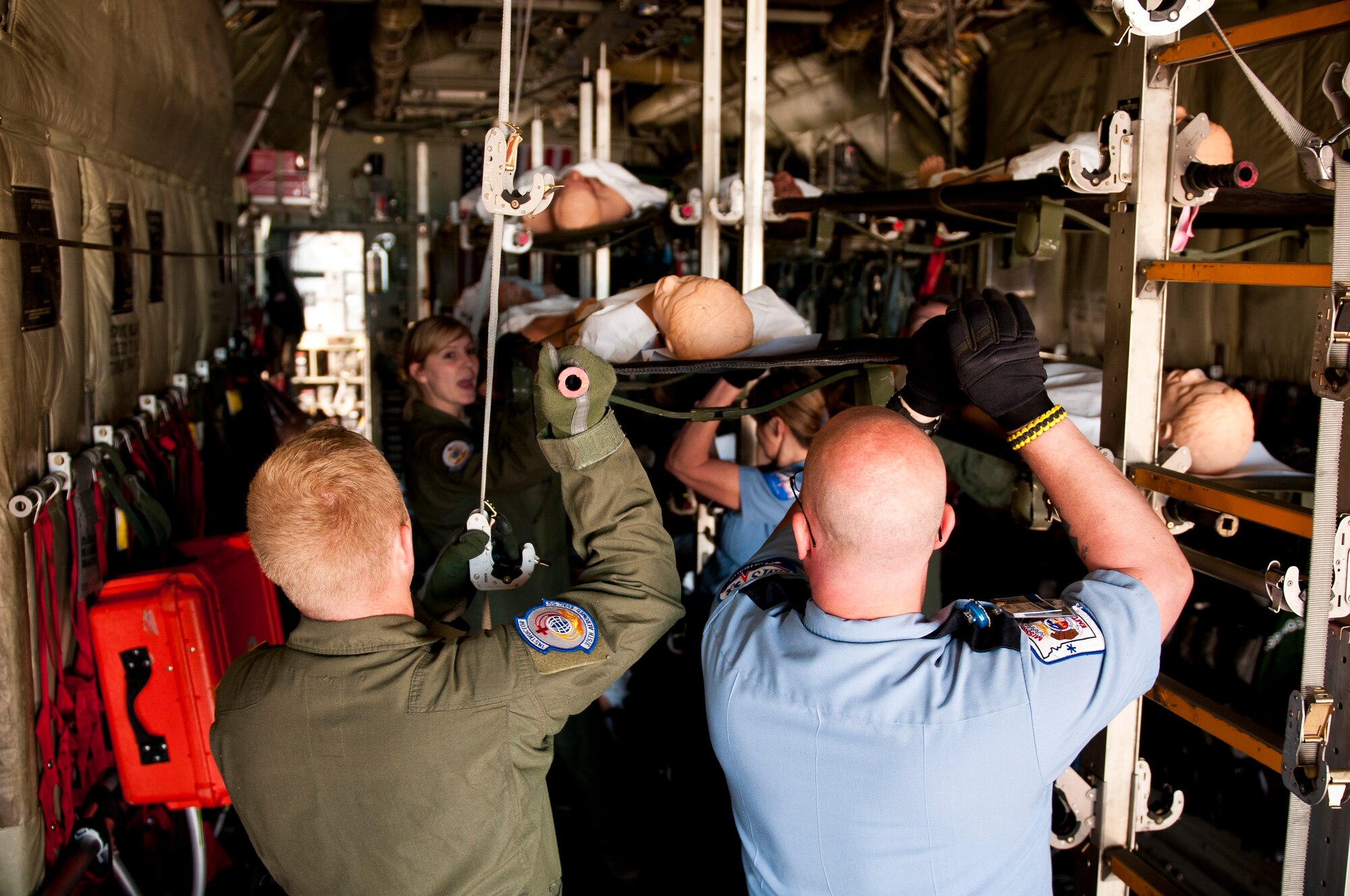 Sgt. Eric Hammerstrom, a medic from the 375th Aeromedical Evacuation Squadron, Scott Air Force Base, Ill., and EMT Basic Jerry Ellis of CoxHealth in Springfield, Mo., lift a simulated patient onto a C-130 Hercules during National Level Exercise 2011 at Springfield-Branson National Airport on May 17, 2011. The exercise is based on a scenario involving a simulated earthquake along the New Madrid fault line. (U.S. Air Force photo by Senior Airman Maxwell Rechel)