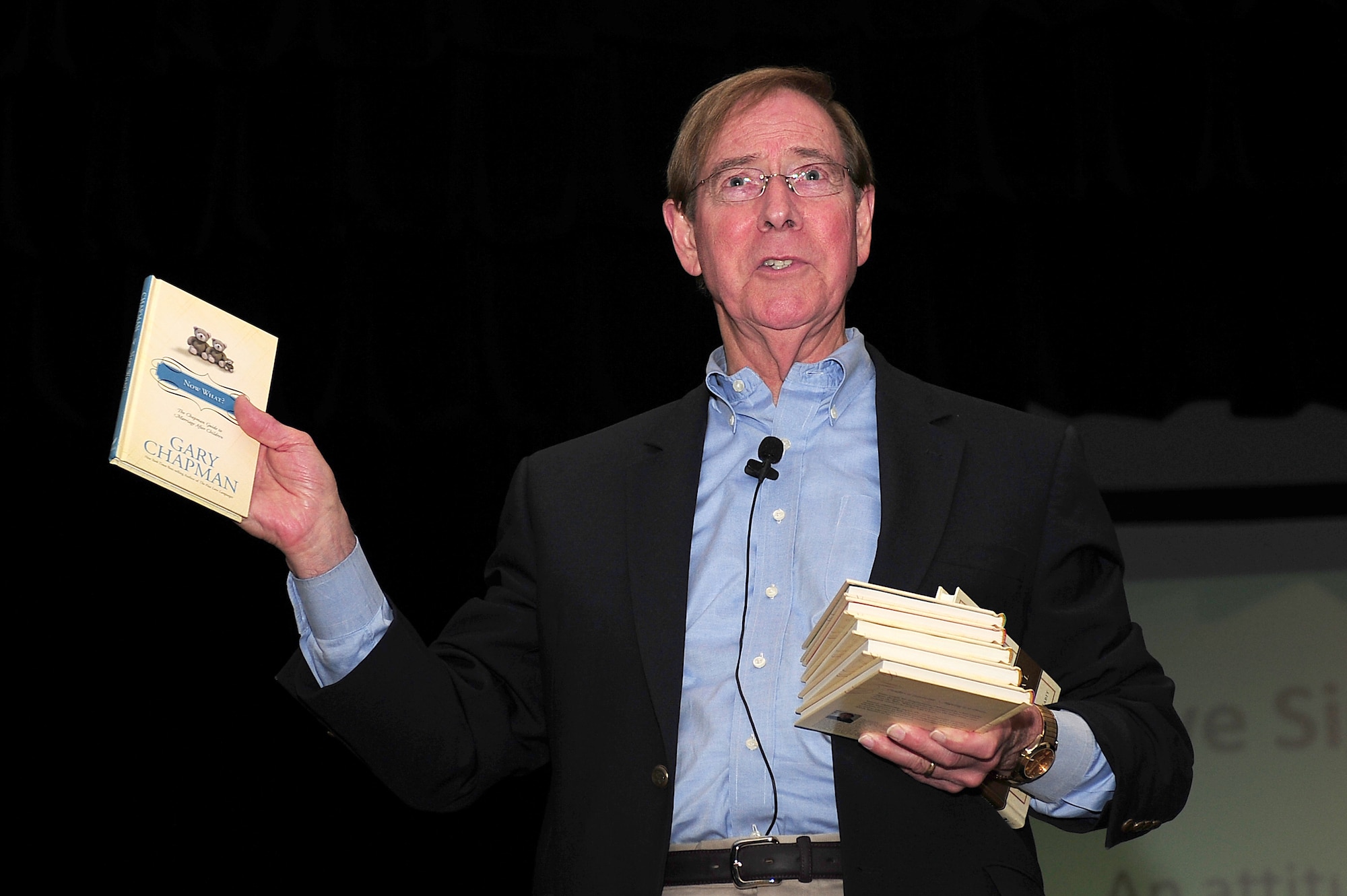 SEYMOUR JOHNSON AIR FORCE BASE, N.C. - Dr. Gary Chapman displays some of his books during a relationship improvement seminar sponsored by the base chapel here, May 17, 2011. Dr. Chapman is a Winston-Salem native and has traveled around the world helping improve family life and marriages. (U.S. Air Force photo/Senior Airman Rae Perry)(RELEASED)
