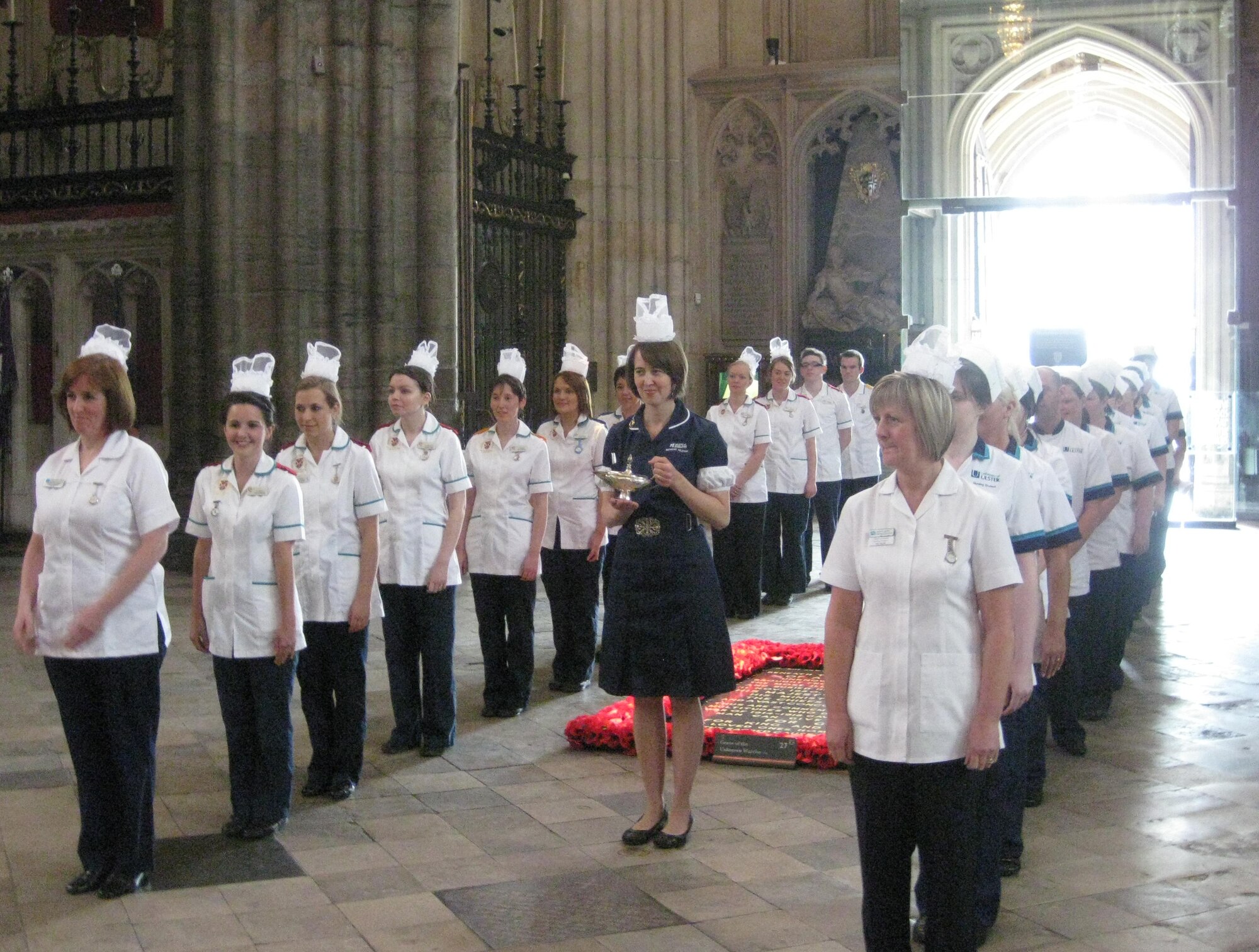 LONDON – British nursing and midwife students from the Open University in East Anglia and Queen’s and Ulster University Schools of Nursing in Northern Ireland, line up to escort the Florence Nightingale Lamp during a ceremony at Westminster Abbey, May 11, 2011.  Nurses and technicians from the 48th Medical Group celebrated Nurses Week by participating in the commemoration ceremony honoring the life and work of Florence Nightingale. The ceremony also honors nurses, midwives and medical support staff world-wide. (Photo courtesy of 48th Medical Group)