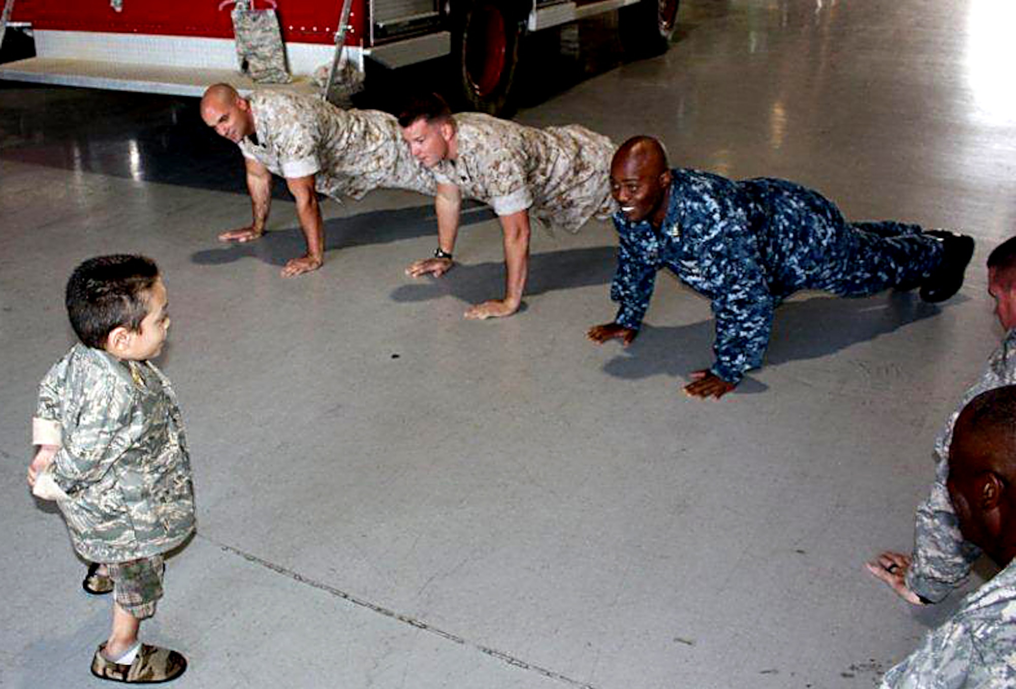 GOODFELLOW AIR FORCE BASE, Texas -- A natural leader, Sergeant Major for the day Shawn Chavez, 8, tells fire academy instructors to drop and give him 10 during his tour at the academy May 18.  Servicemembers from the Army, Air Force Navy and Marine Corps hosted Shawn and his family as part of the young boy's wish to meet a Soldier. (U.S. Army photo/Staff Sgt. Michael Carlson)