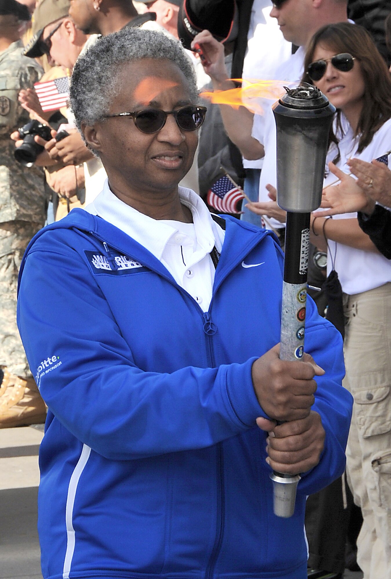 Retired Maj. Gwendolyn Sheppard caries the torch during the opening ceremony of the 2011 Warrior Games May 16, 2011, in Colorado Springs, Colo. Major Sheppard was selected by her teammates for the honor of being the torch bearer for the Air Force team. (U.S. Air Force photo/Duncan Wood)