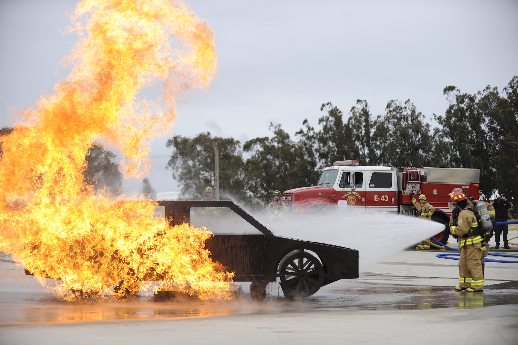 VANDENBERG AIR FORCE BASE, Calif. -- Putting out the fire, Lt. Gen. Susan Helms, Joint Functional Component Command for Space and 14th Air Force commander, extinguishes a simulated burning vehicle during her immersion tour Tuesday, May 17, 2011.  During her tour, the general learned about the technical aspects of the firefighter career field and had the chance to extinguish simulated car and structural fires. (U.S. Air Force photo/Staff Sgt. Andrew Satran) 
