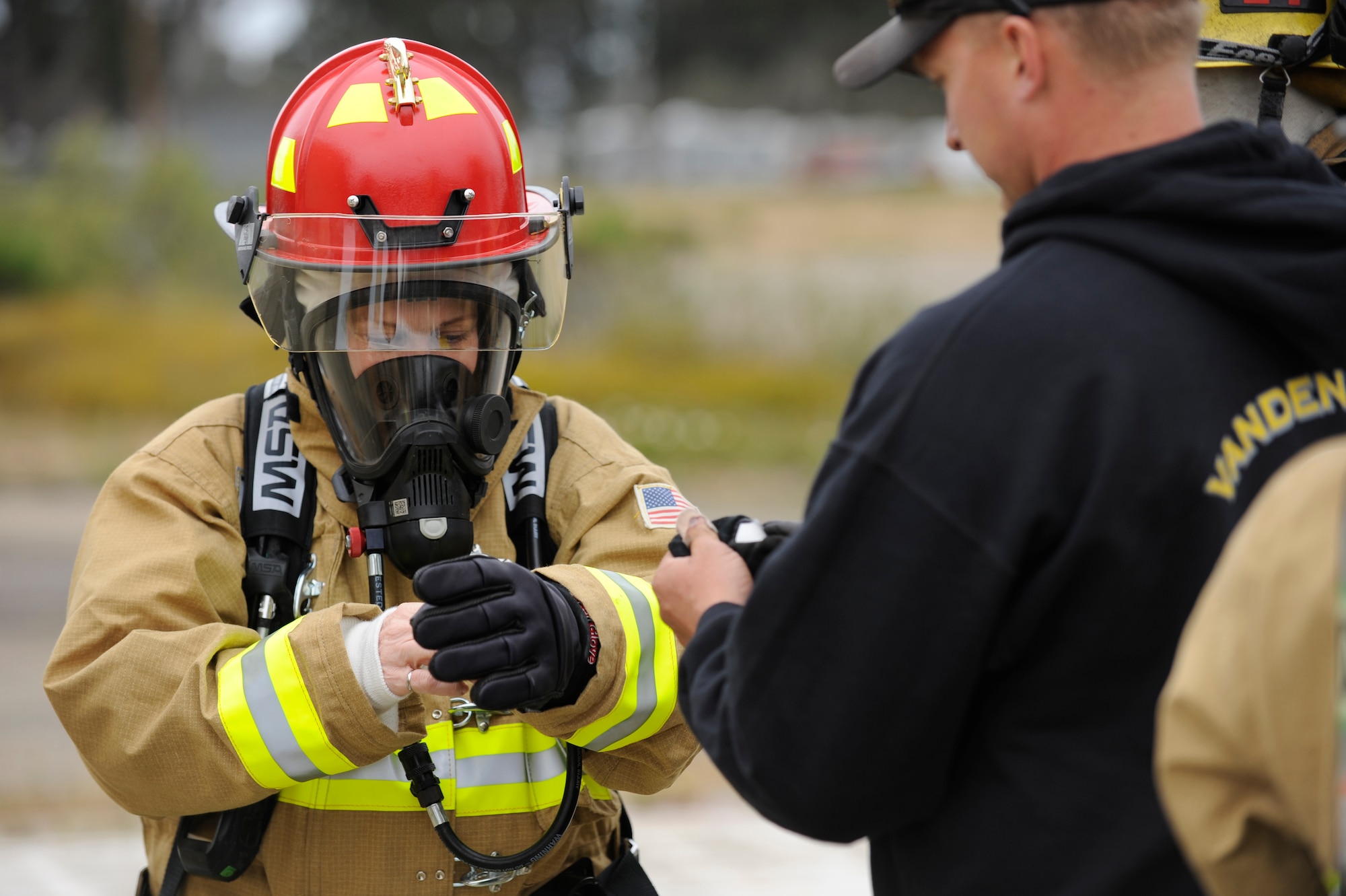 VANDENBERG AIR FORCE BASE, Calif. -- Lt. Gen. Susan Helms, Joint Functional Component Command for Space and 14th Air Force commander, puts her fire safe gloves on during her immersion tour with the Vandenberg Air Force Base Fire Department on Tuesday, May 17, 2011.  During her tour, the general learned about the technical aspects of the firefighter career field and had the chance to extinguish simulated car and structural fires. (U.S. Air Force photo/Staff Sgt. Andrew Satran) 

 