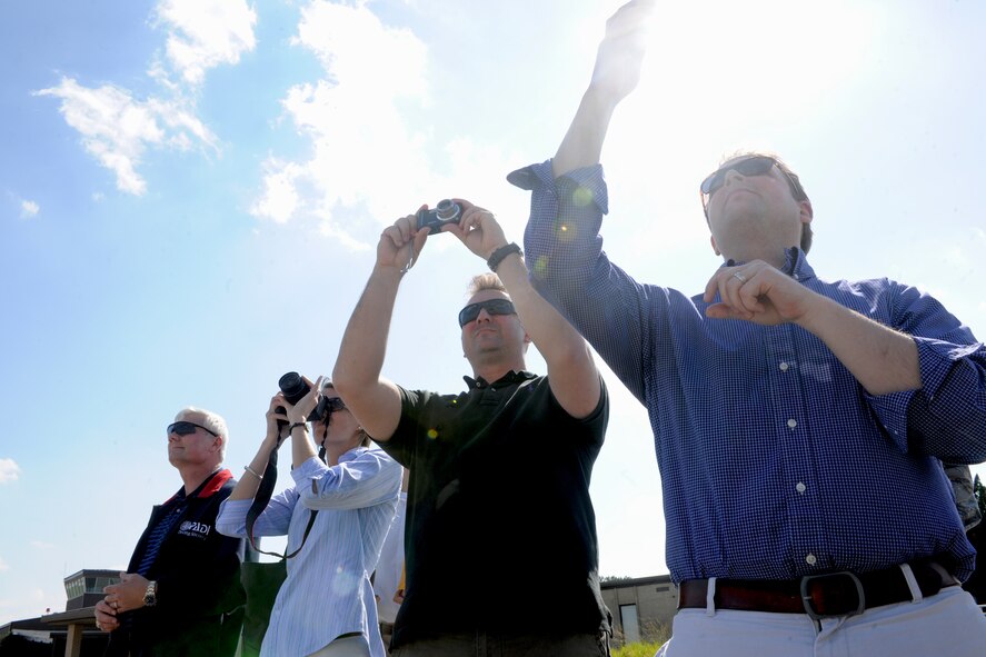 Congressional Staff members take photos as the A-10 East Demonstration Team performs aerobatic maneuvers overhead during a visit to Moody Air Force Base, Ga., May 17. The Congressional Staffers toured the 23rd Fighter Group, 347th Rescue Group, and 93rd Air Ground Operations Wing. They were able to ask questions about the different missions in order to report back to the Congressmen about Moody’s impact on current combat operations.  (U.S. Air Force photo/Airman 1st Class Benjamin Wiseman)(RELEASED)