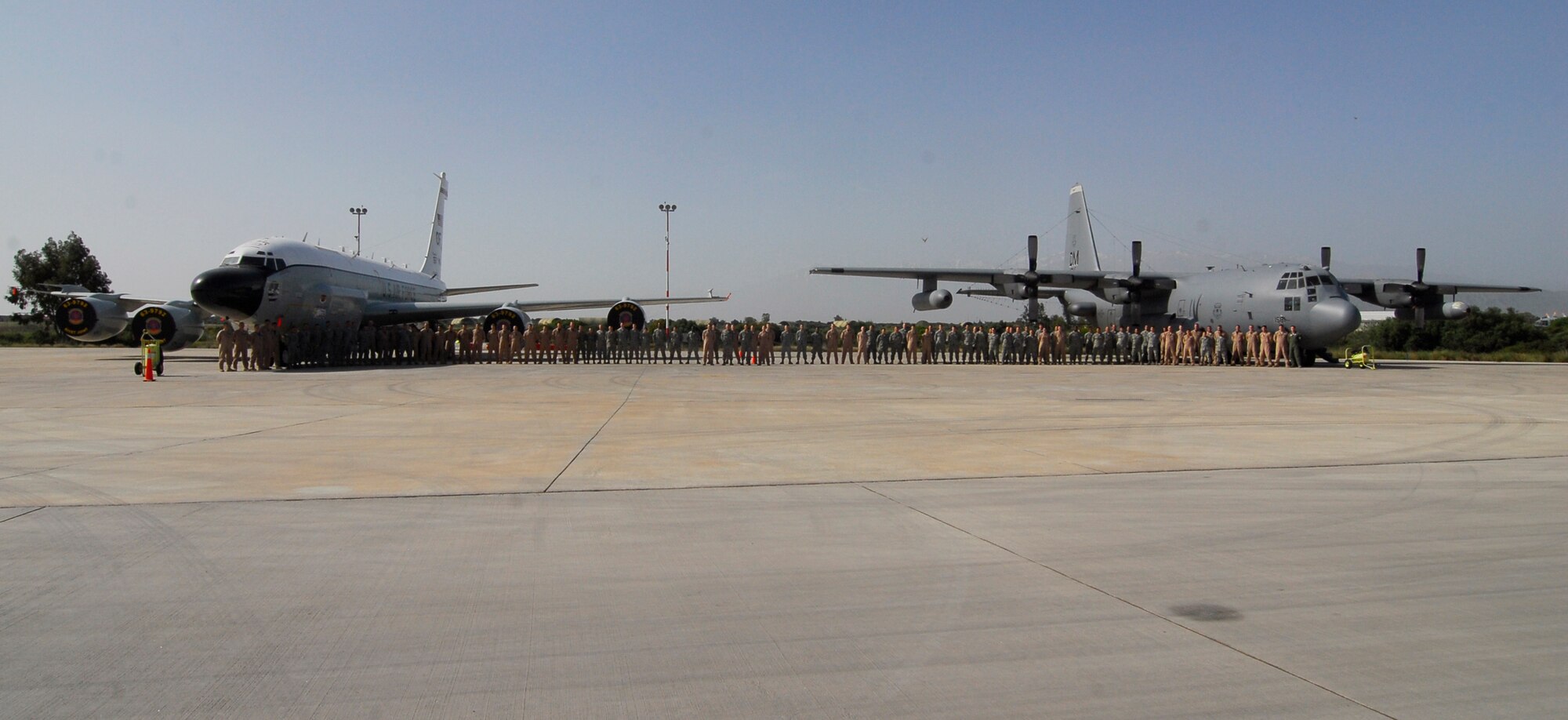 Naval Support Activity Souda Bay, Greece -- Crews members from an RC-135V/W
Rivet Joint and an EC-130H Compass Call pose for a photo together here
recently. The two Fightin' Fifty-Fifth teams were here flying Operation
Odyssey Dawn missions in support of Africa Command and NATO. The Rivet Joint
provides near real time on-scene intelligence collection, analysis and
dissemination capabilities while the Compass Call jams radars, disrupts
enemy command and control, and degrades the enemy's ability to communicate.
