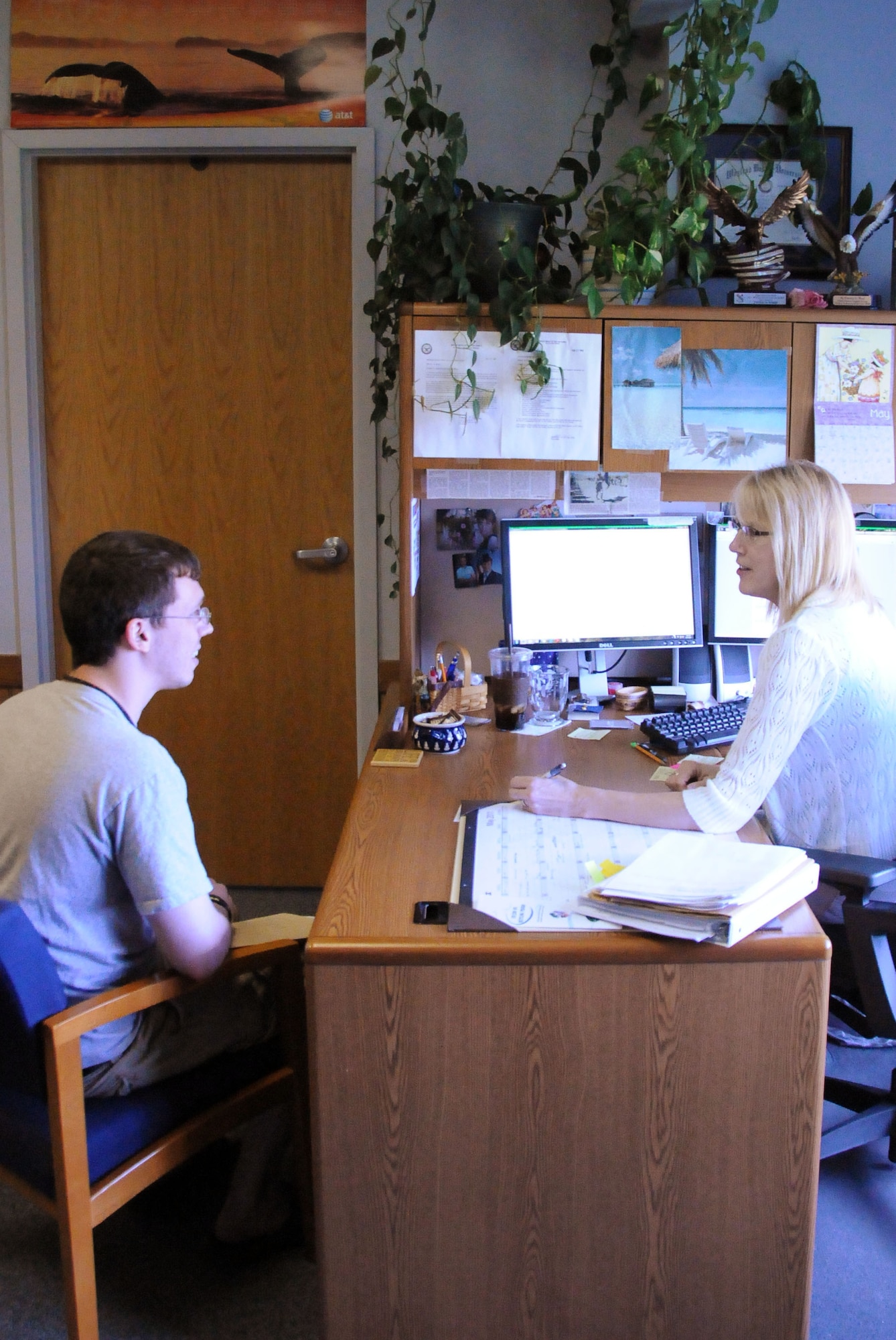 Patricia Ward reviews Airman 1st Class Allen Gratzer's student information online May 17, 2011, Eielson Air Force Base, Alaska. The education office provides information and advises customers in areas dealing with their educational and developmental needs. Ms. Ward is an education specialist at the Eielson education office. Airman Gratzer is a 354th Civil Engineer Squadron Simplified Acquisition Base Engineering Requirements project manager. (U.S. Air Force photo/Airman 1st Class Janine Thibault)