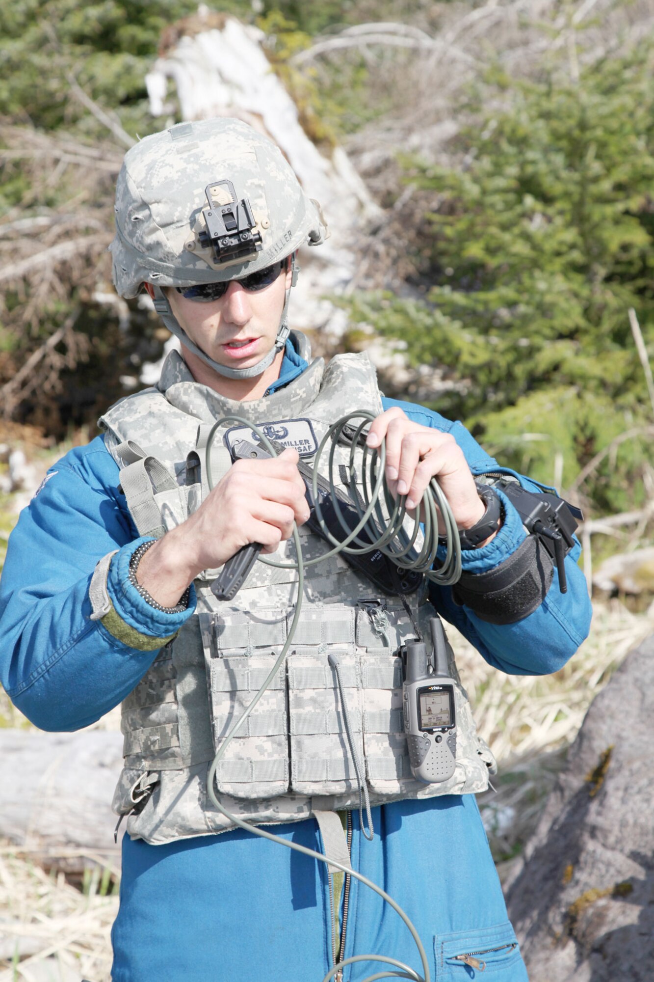 Senior Airman Jason Miller, an explosive ordnance disposal technician from Joint Base Elmendorf-Richardson, counts “ticks” of fuse cord – each tick indicates a certain amount of burn time - to set off a detonation to destroy a World War II-era mine on the beach north of Sitka, Alaska recently. (Courtesy photo)