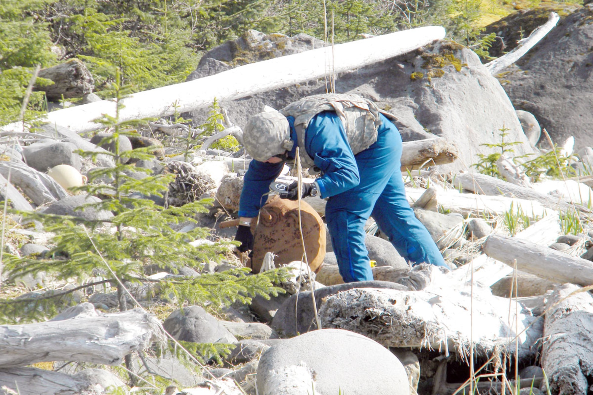 Air Force Staff Sgt. Shawn Briggs, EOD team chief, measures the rusted mine to gather information to pass along to other EOD technicians as well as to ensure the team uses the right amount of explosives to destroy it completely. Once the mine was destroyed, there were only small fragments. “One high tide, and there won’t be a trace left,” Miller said. (Courtesy photo)