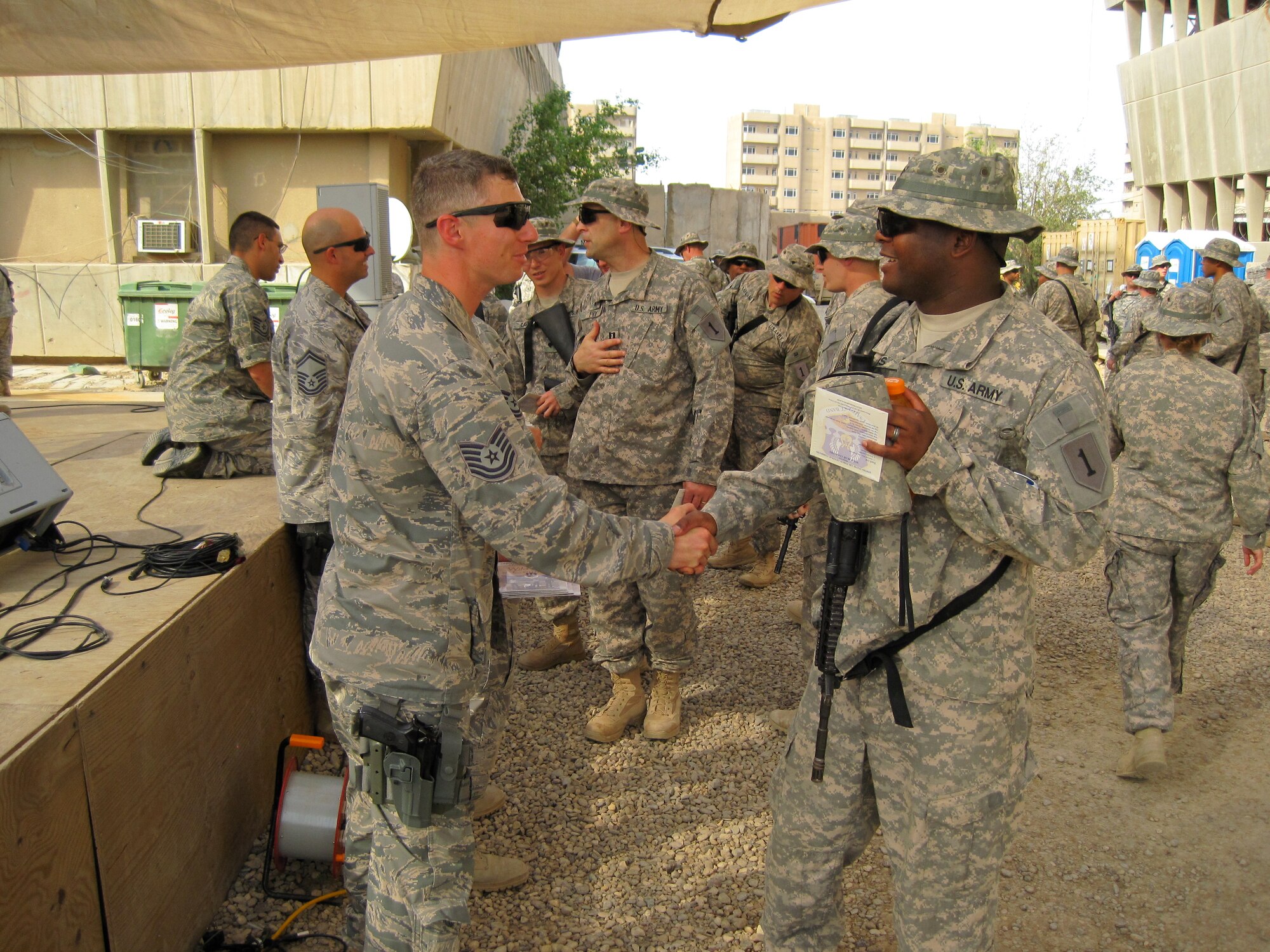 Technical Sgt. Tim Stombaugh & other Wild Blue Country members hand out CD's while greeting COB Loyalty troops. (U.S. Air Force photo by Master Sgt. Karl Bradley)