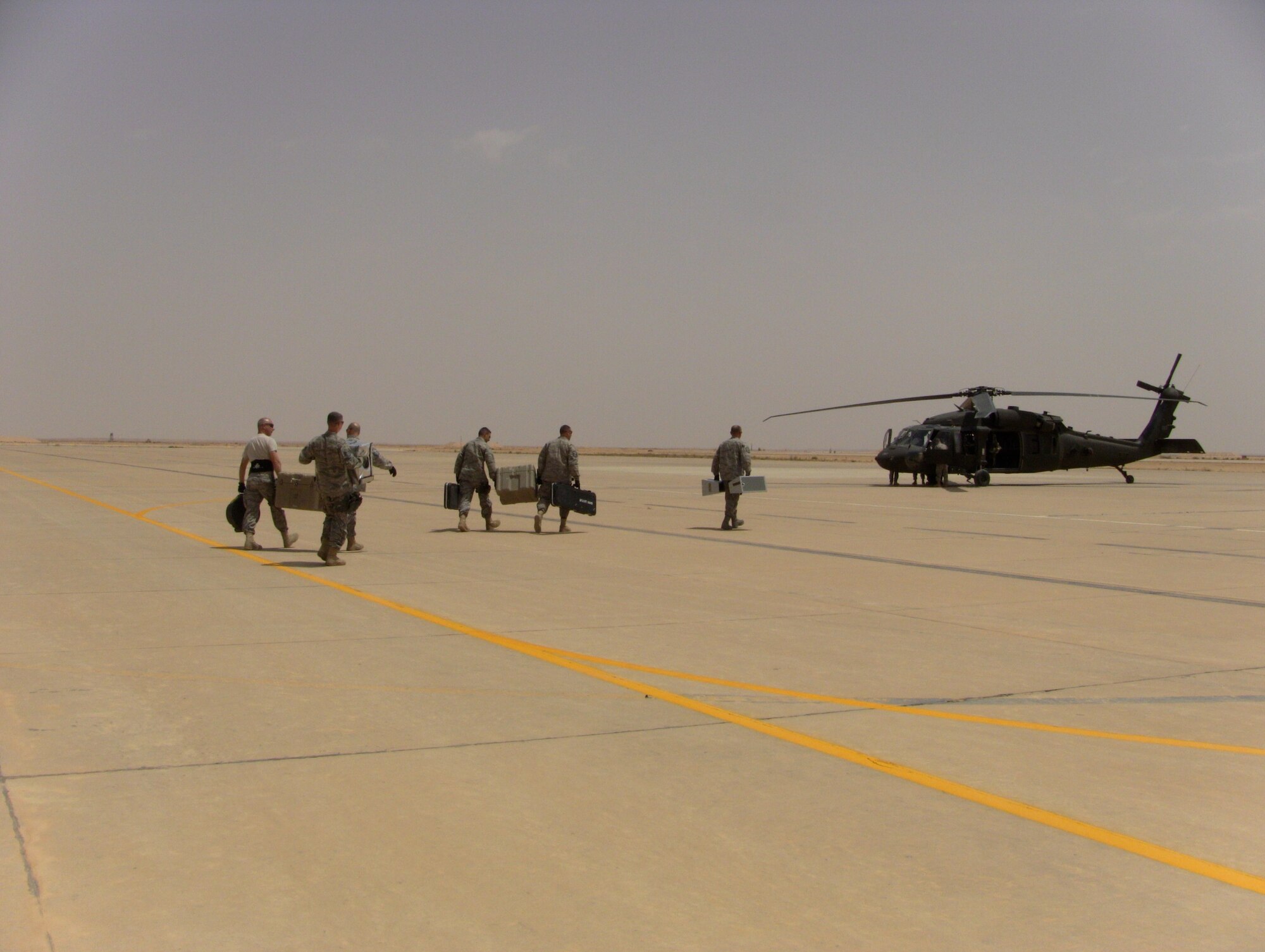 AFCENT Band Wild Blue Country loads gear onto a Blackhawk. (U.S. Air Force photo by Master Sgt. Karl Bradley)