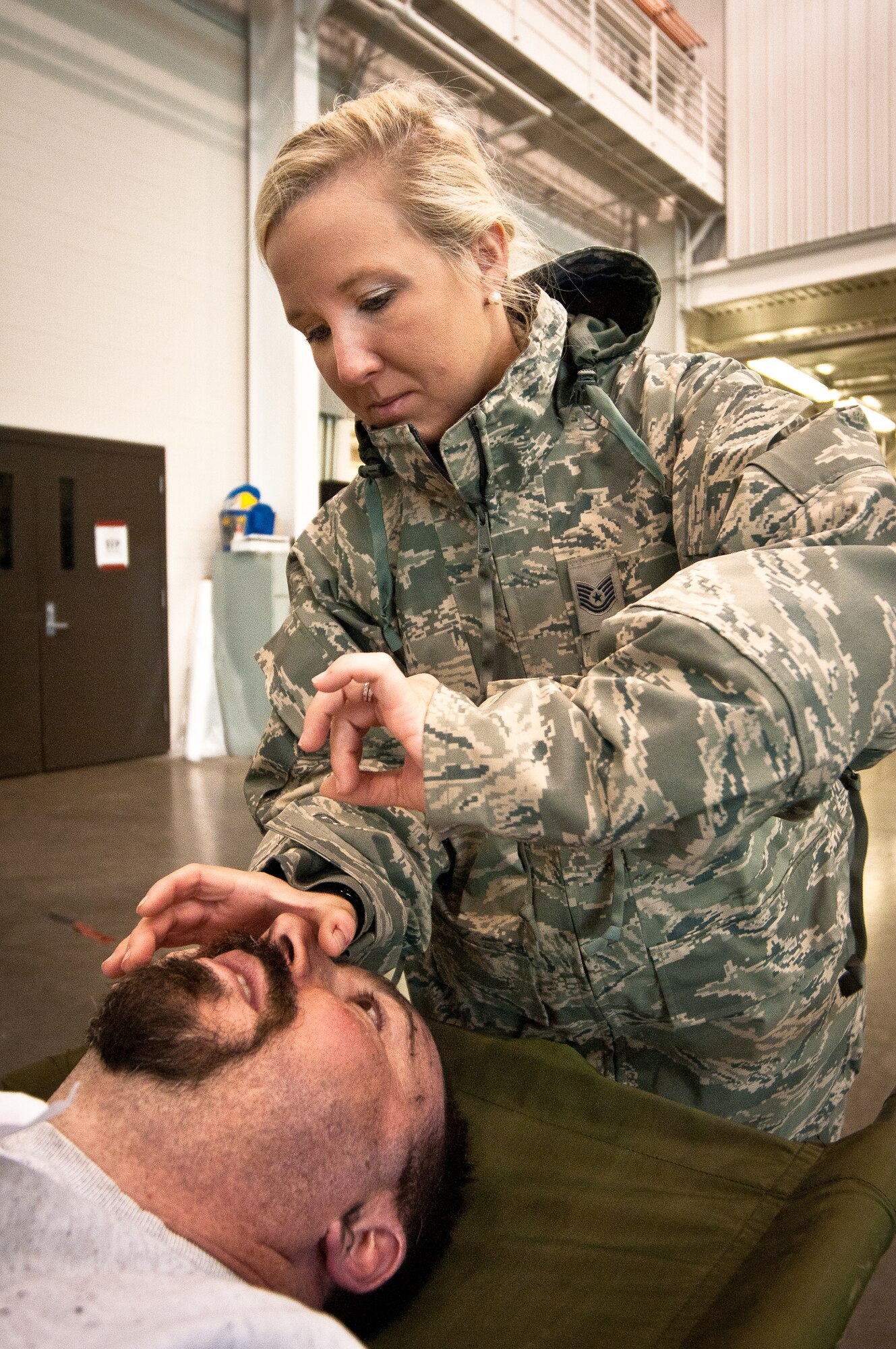 Tech. Sgt. Heather Speidel, a medic with the Kentucky Air National Guard’s 123rd Medical Group, simulates inserting a breathing tube in the windpipe of a notional plane-crash victim during earthquake-response exercises held May 18, 2011, at the Kentucky Air National Guard Base in Louisville, Ky. The exercises were designed to test the ability of the Department of Veterans Affairs and the Kentucky Air Guard to provide medical care following a major earthquake along the New Madrid fault line. (U.S. Air Force photo by Maj. Dale Greer)