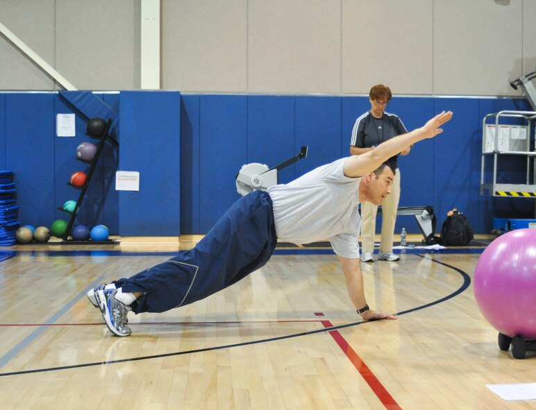 U.S. Air Force Staff Sgt. Shane Campbell demonstrates a plank modification during his group exercise practical exam at the end of the Cooper Institute's Military Exercise Leader course at March Air Reserve Base, Calif., May 12, 2011.  The course is part of an ongoing effort to create a culture of fitness at the base.  (U.S. Air Force photo/ Megan Just)